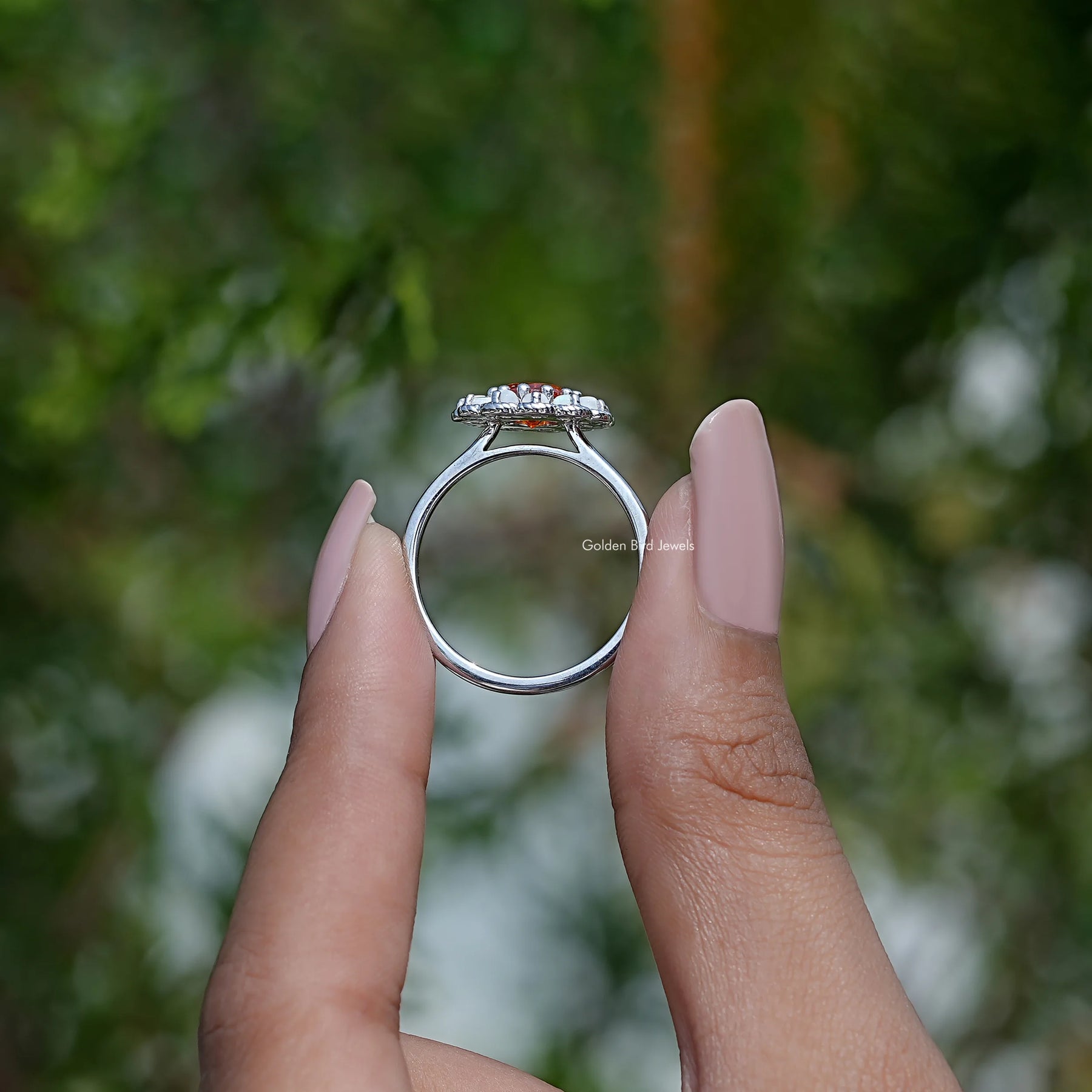 Back View of Round Cut Sunstone Engagement Ring in two fingers