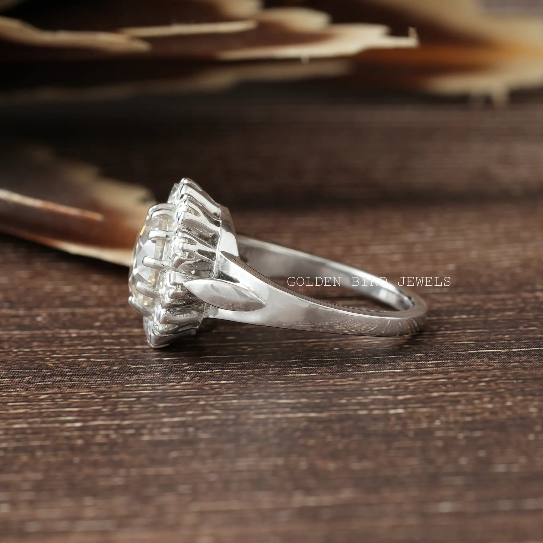 Side View of Round Cut Moissanite Engagement Ring In two fingers