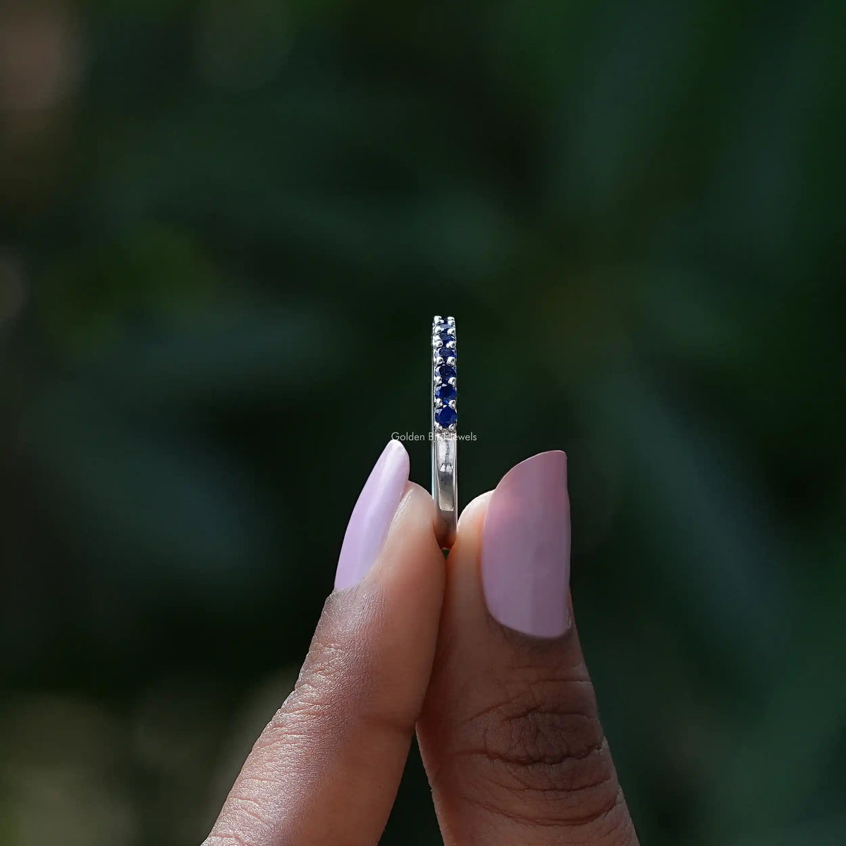 Side view of September Birthstone Sapphire Blue Round Eternity Band