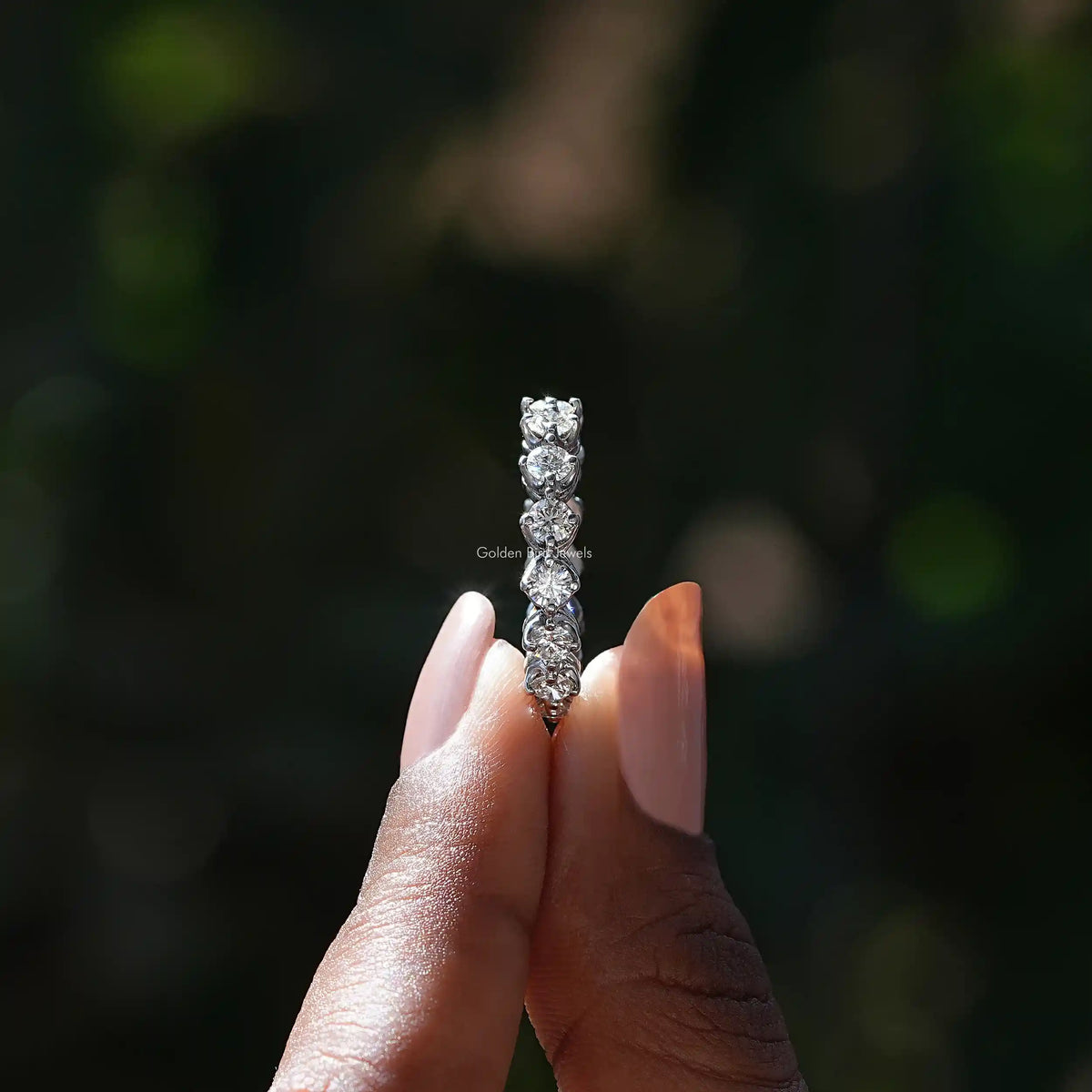 Side View of Round Cut Diamond Eternity Wedding Band In two fingers