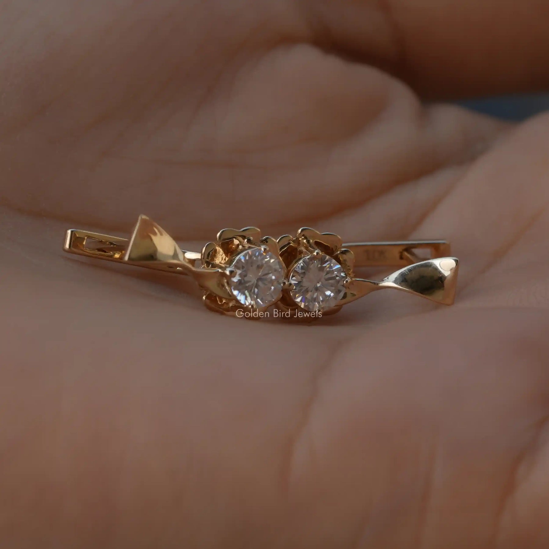 In hand view of round cut cluster earrings
