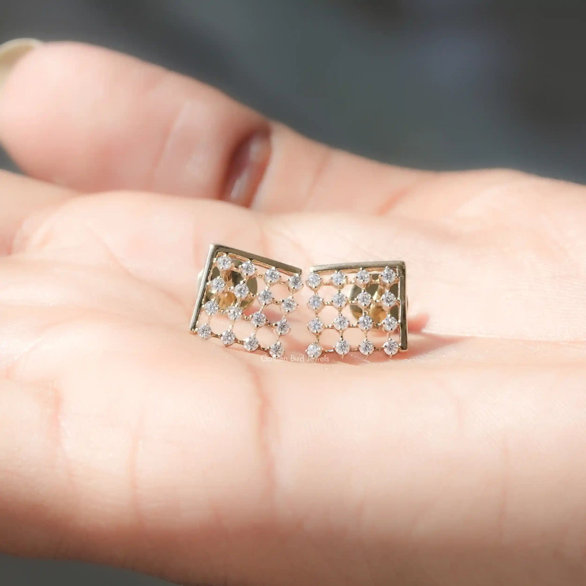 In Hand View Of  round cut moissanite stud Earring