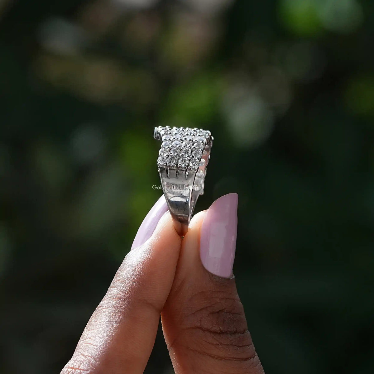 Side View of Round Cut Moissanite Eternity Wedding Band In two fingers