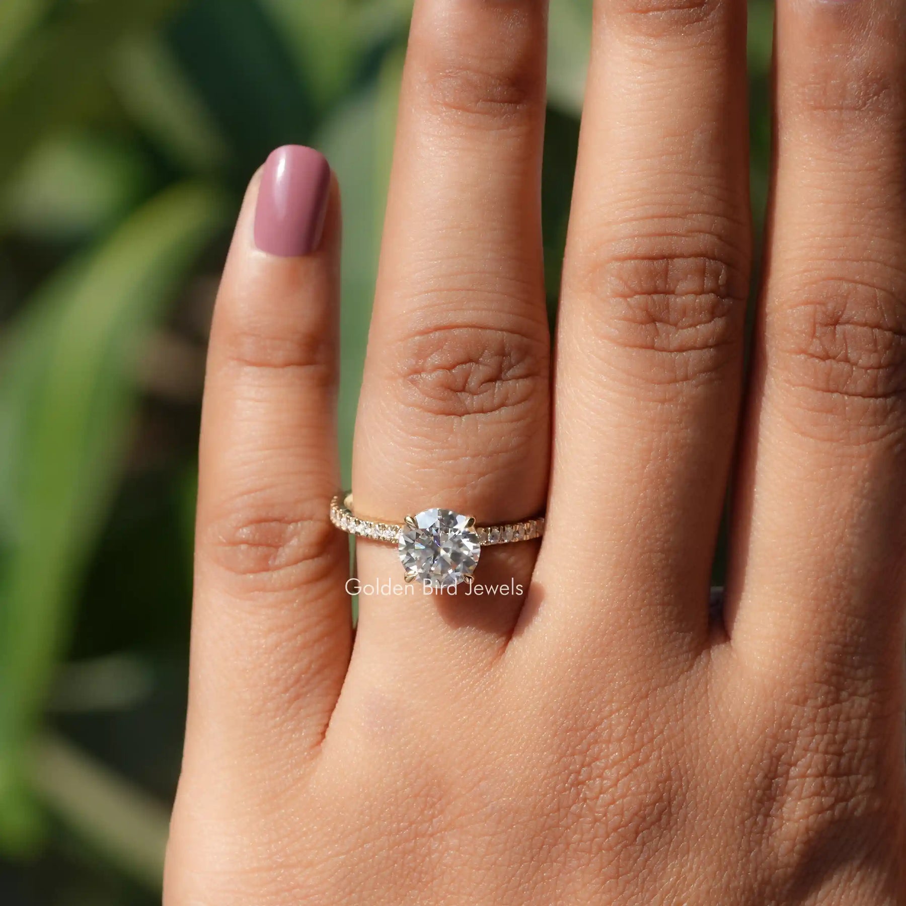 Close-Up View of Moissanite Round Cut Accent Stone Ring In Yellow Gold