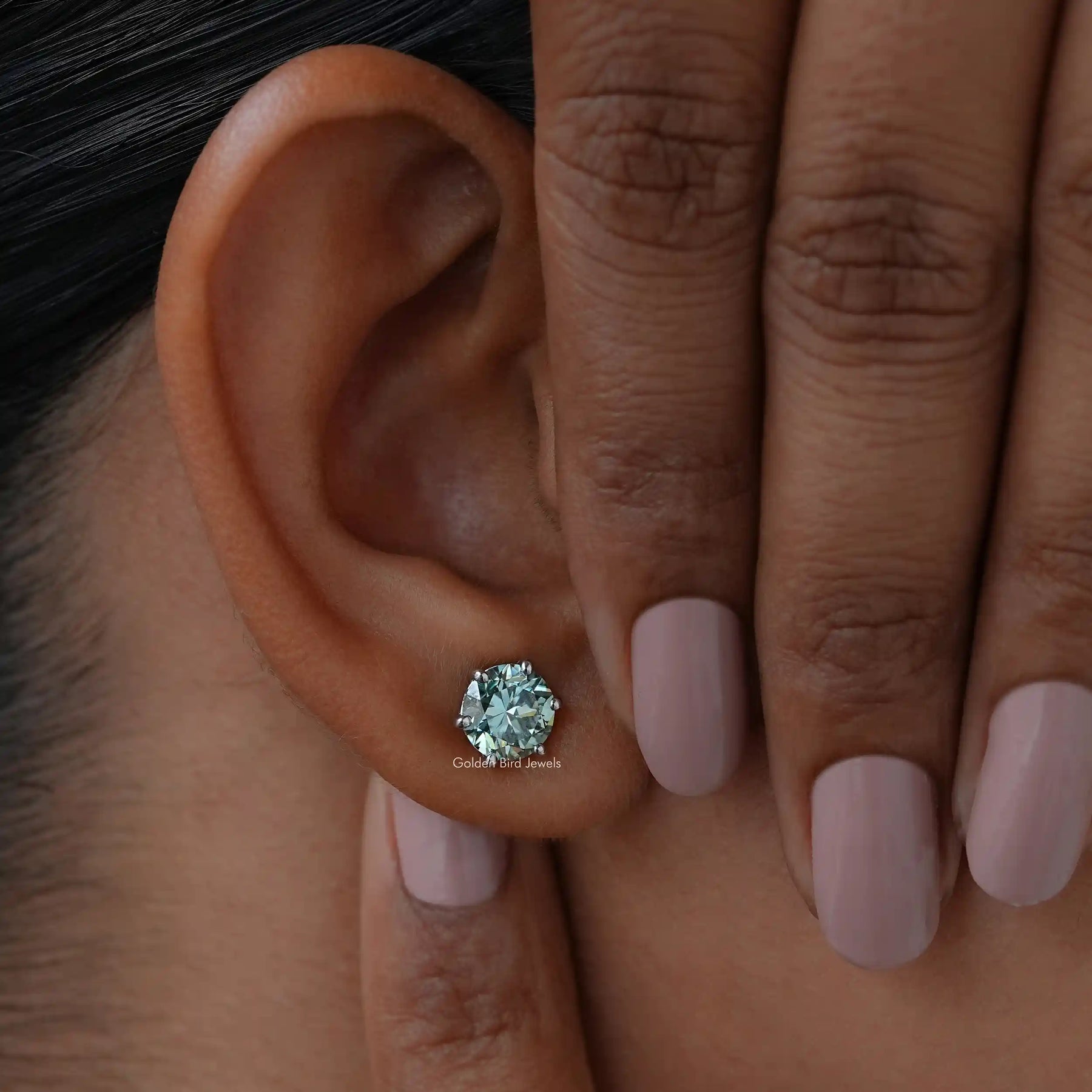 Close view of moissanite stud earrings in unique design