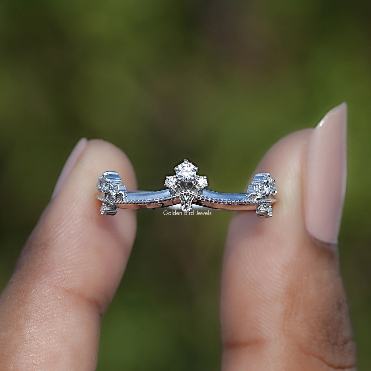 Round Shaped Lab Diamond Curved Distance Wedding Band Held Between Fingers