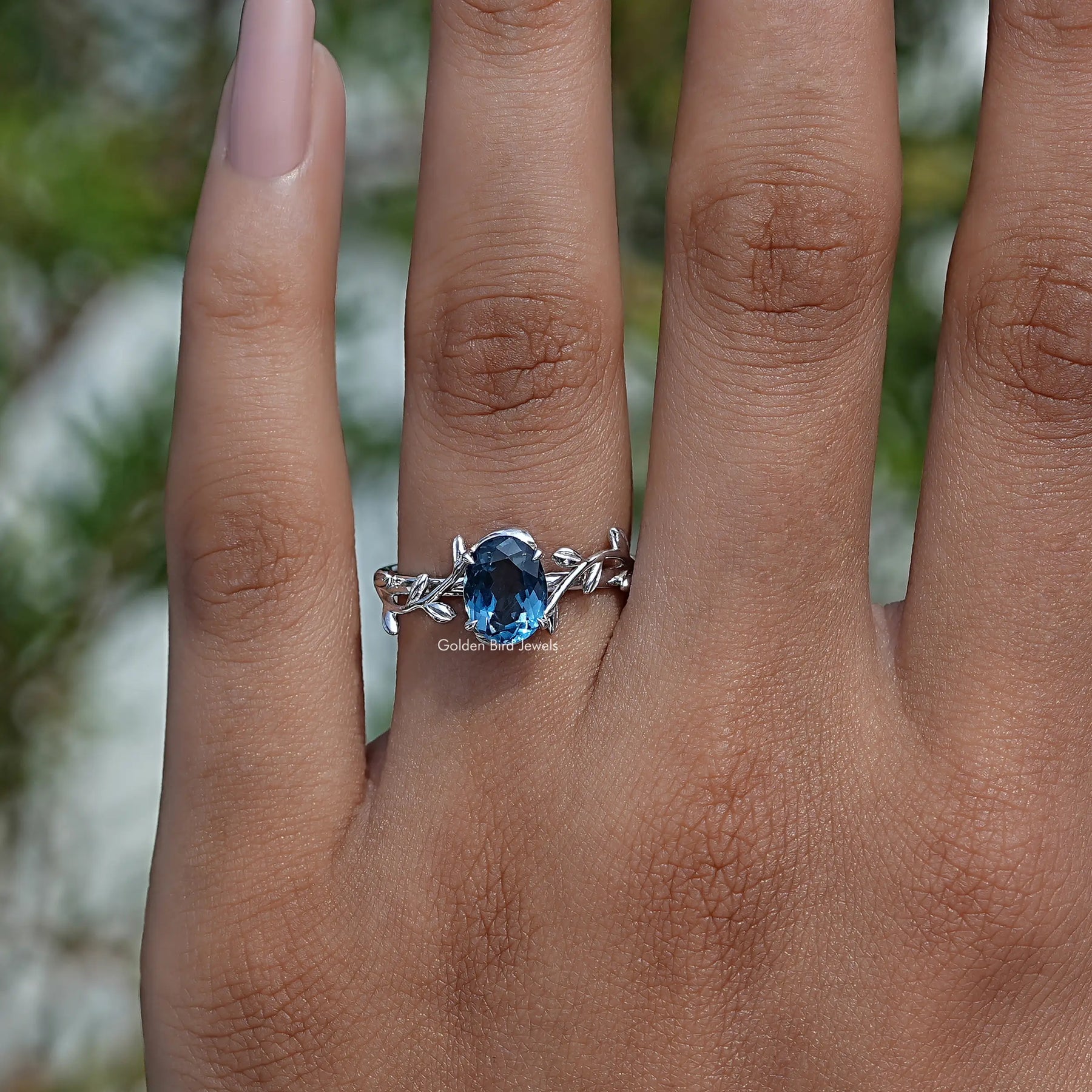 Close-Up View of Oval Cut Blue Sapphire Gemstone Engagement Ring In White Gold