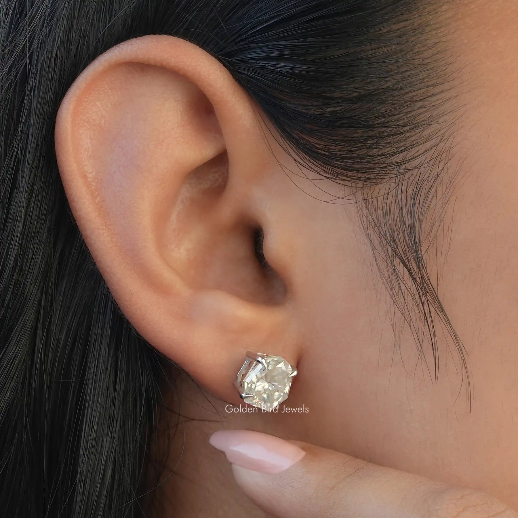 View of colorless moissanite earrings in secure setting