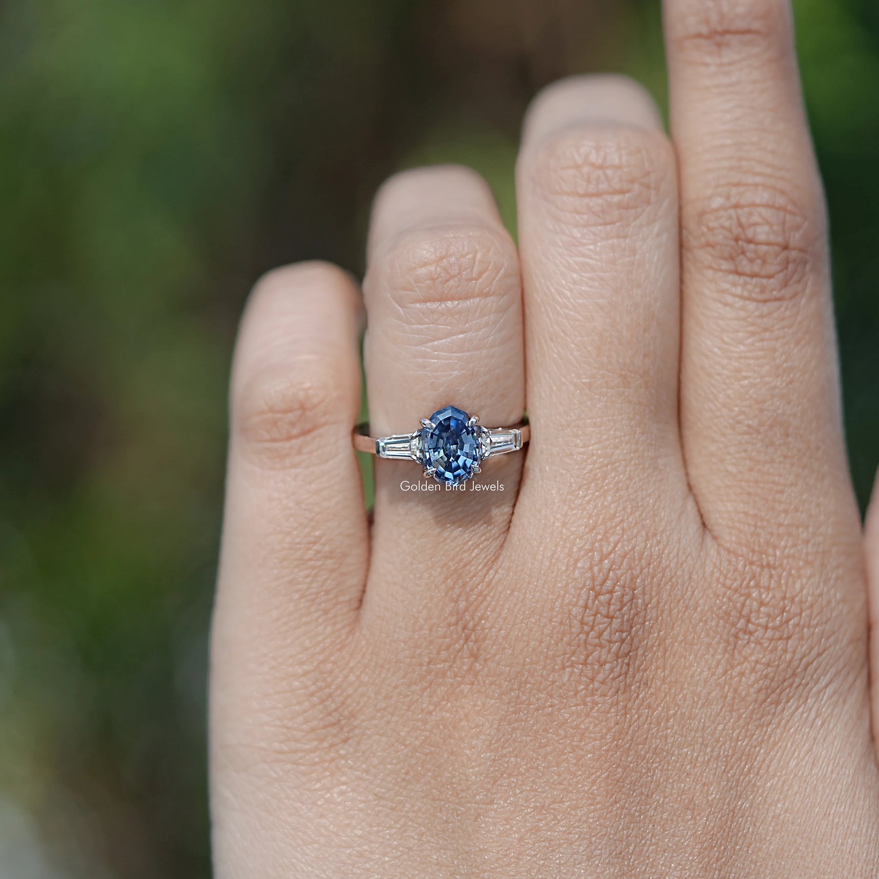 In finger front view of halo Oval Moissanite engagement ring