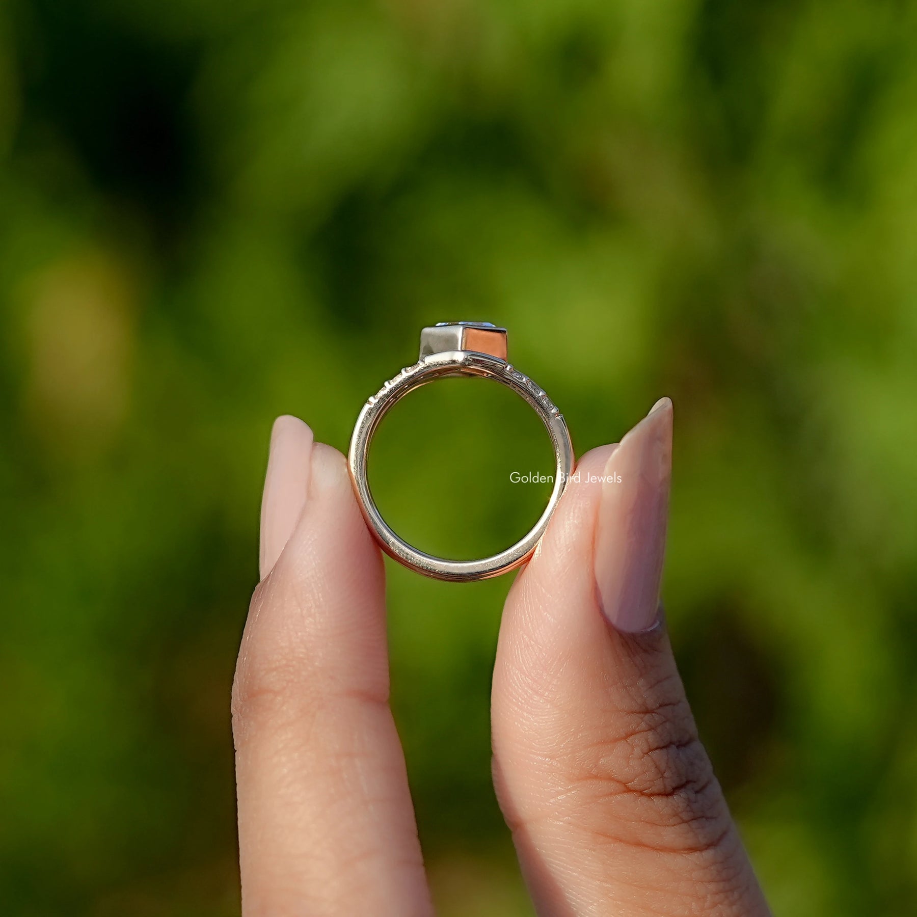 Back View of Kite Cut lab Diamond Engagement Ring In two fingers