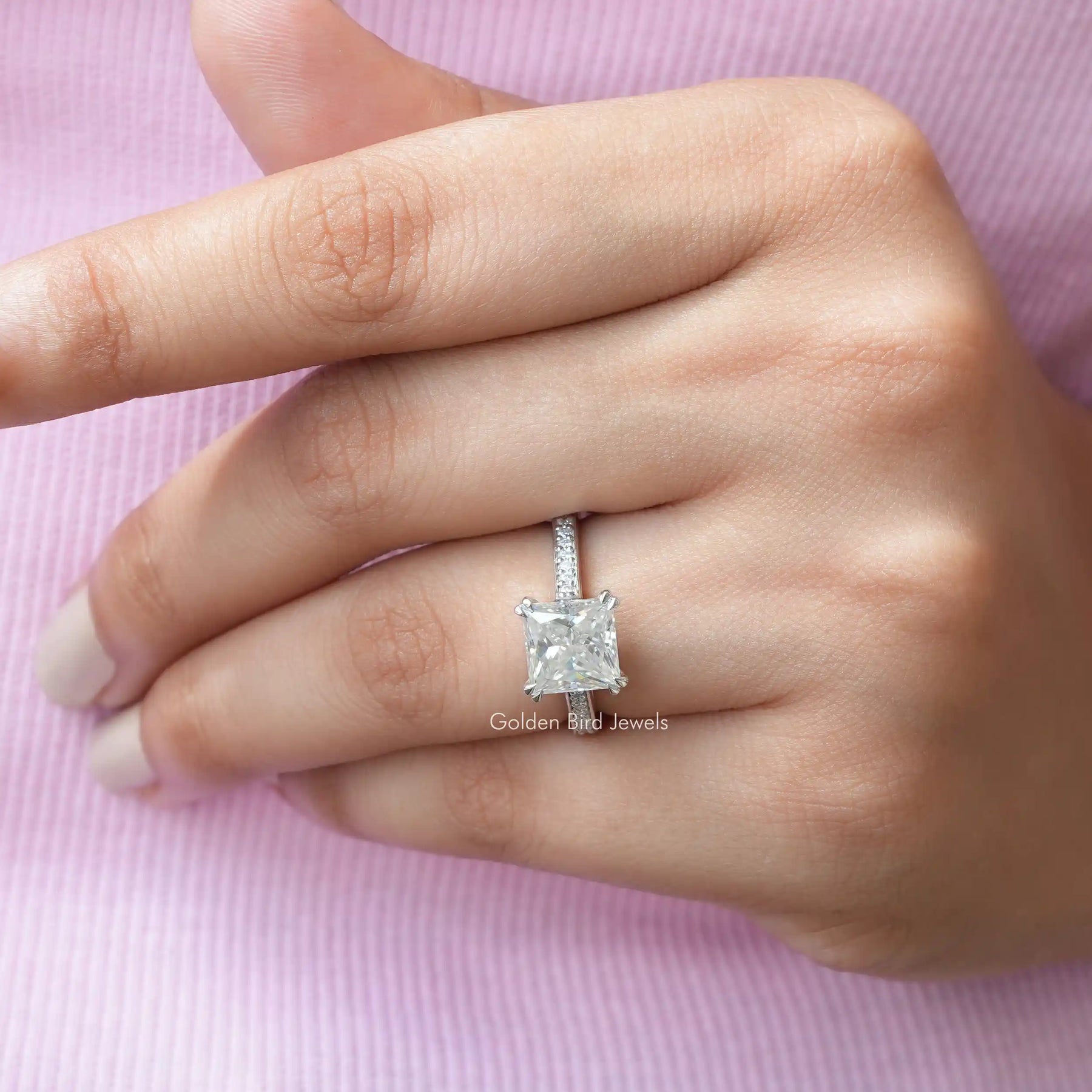 view of solitaire moissanite engagement ring In finger