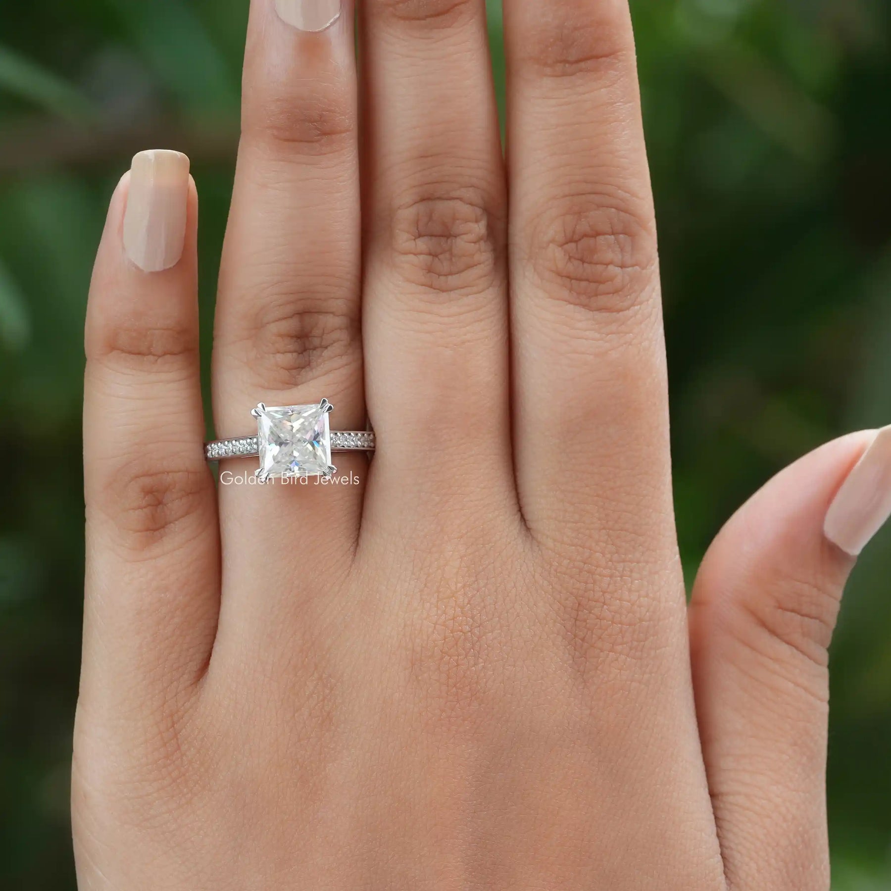 view of princess cut moissanite engagement ring in finger