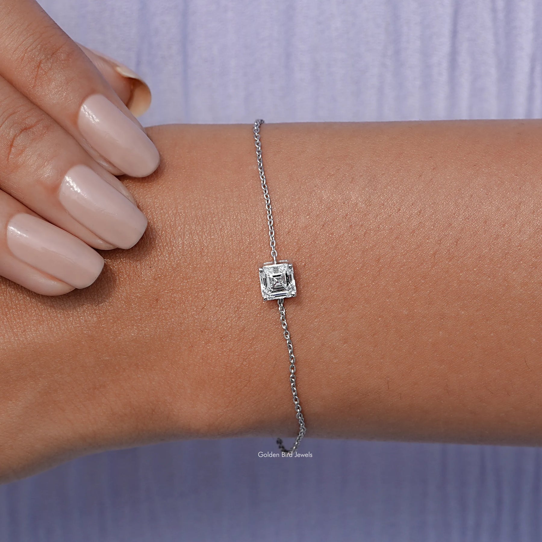 In hand view of diamond delicate chain bracelet