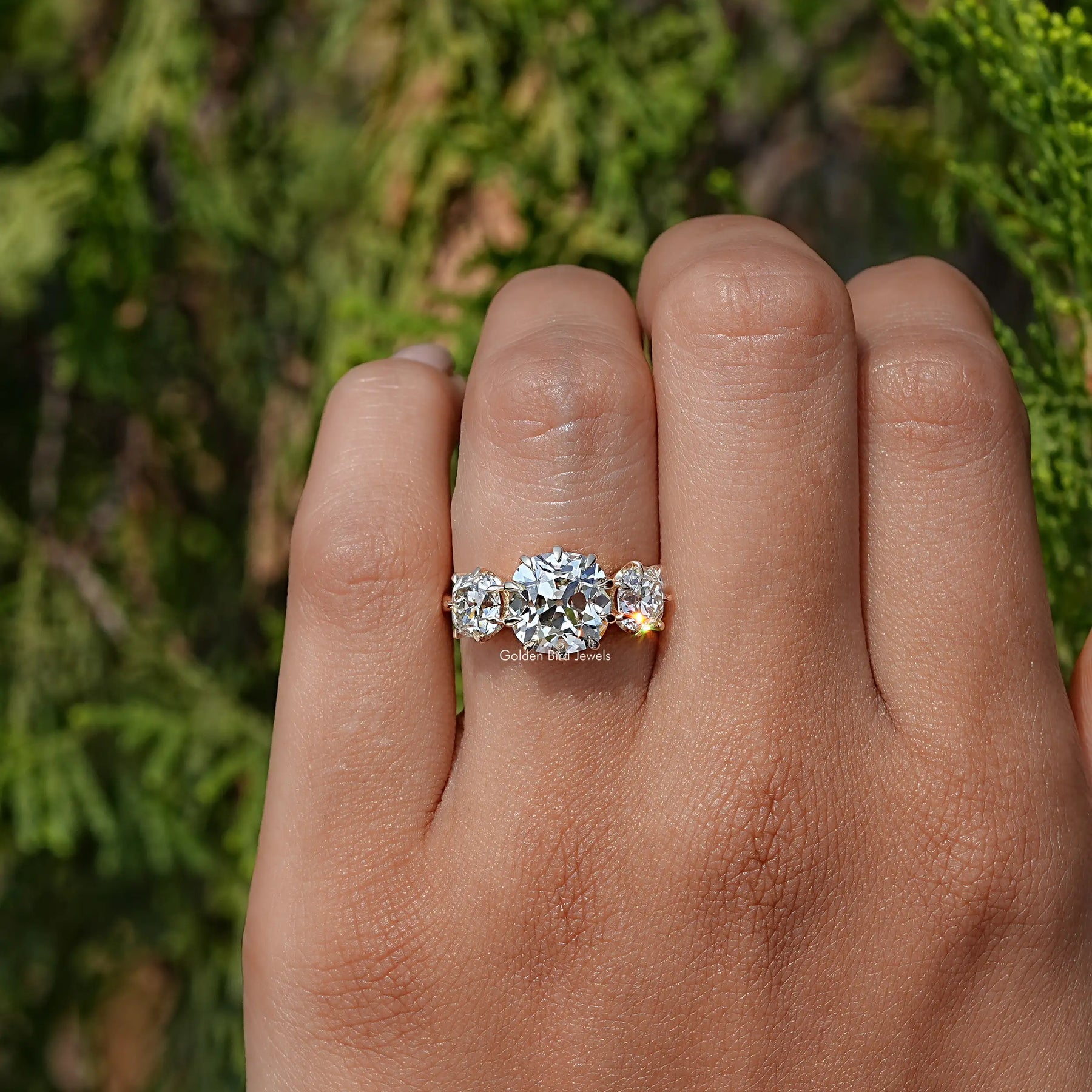 View of Cushion Cut Diamond Three Stone Engagement Ring In Yellow Gold