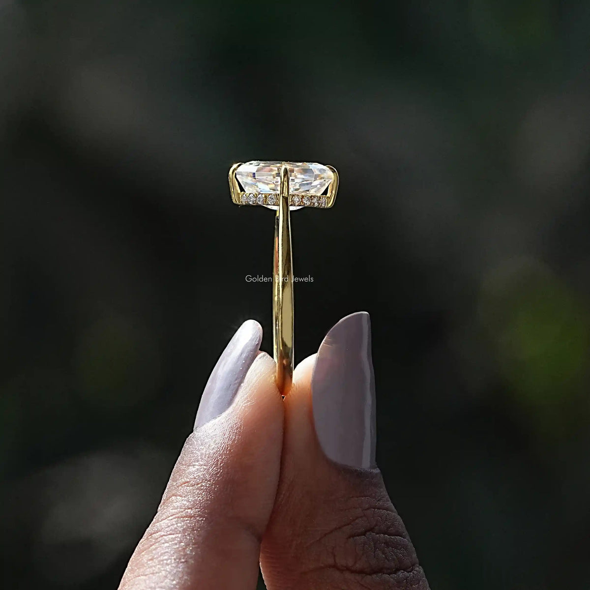 Side View of Oval Cut Moissanite Hidden Halo Ring In two fingers