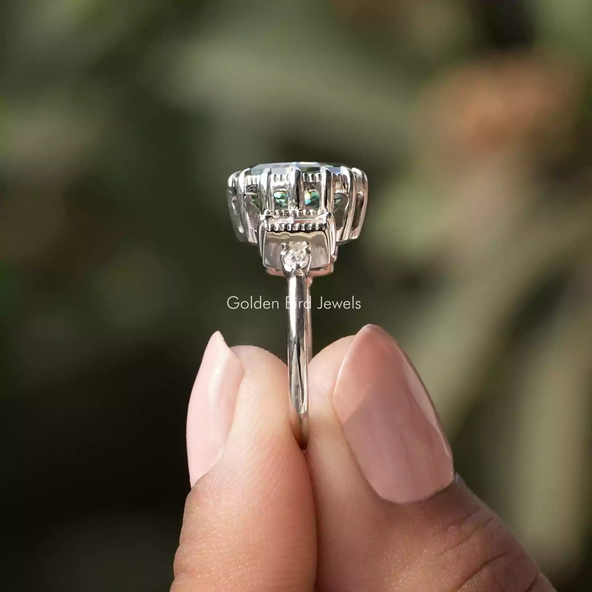 Side View of Green Oval Cut Moissanite Engagement Ring In two fingers