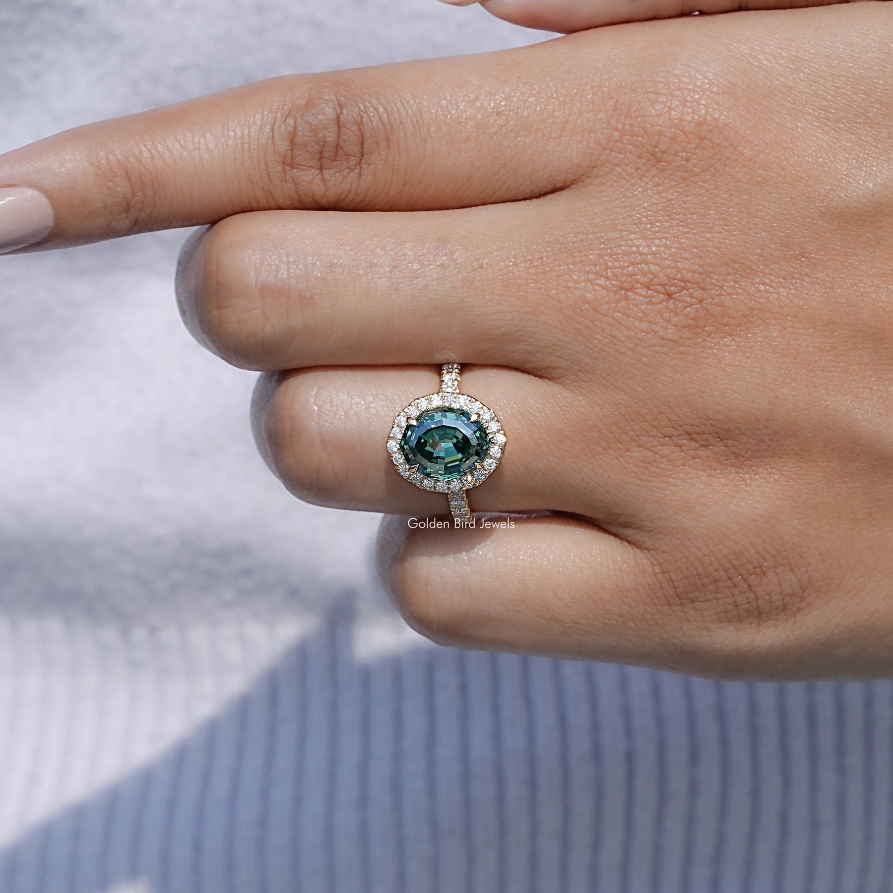 In finger front view of Moissanite Engagement Ring in Step Cut Oval Moissanite in unique shape