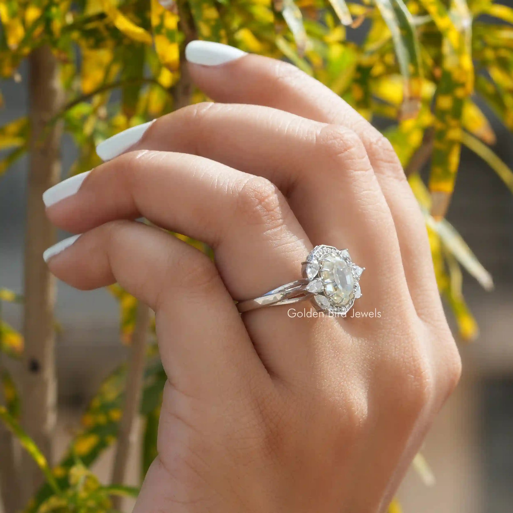 View of Step Cut Oval Moissanite Vintage Halo Ring In Finger