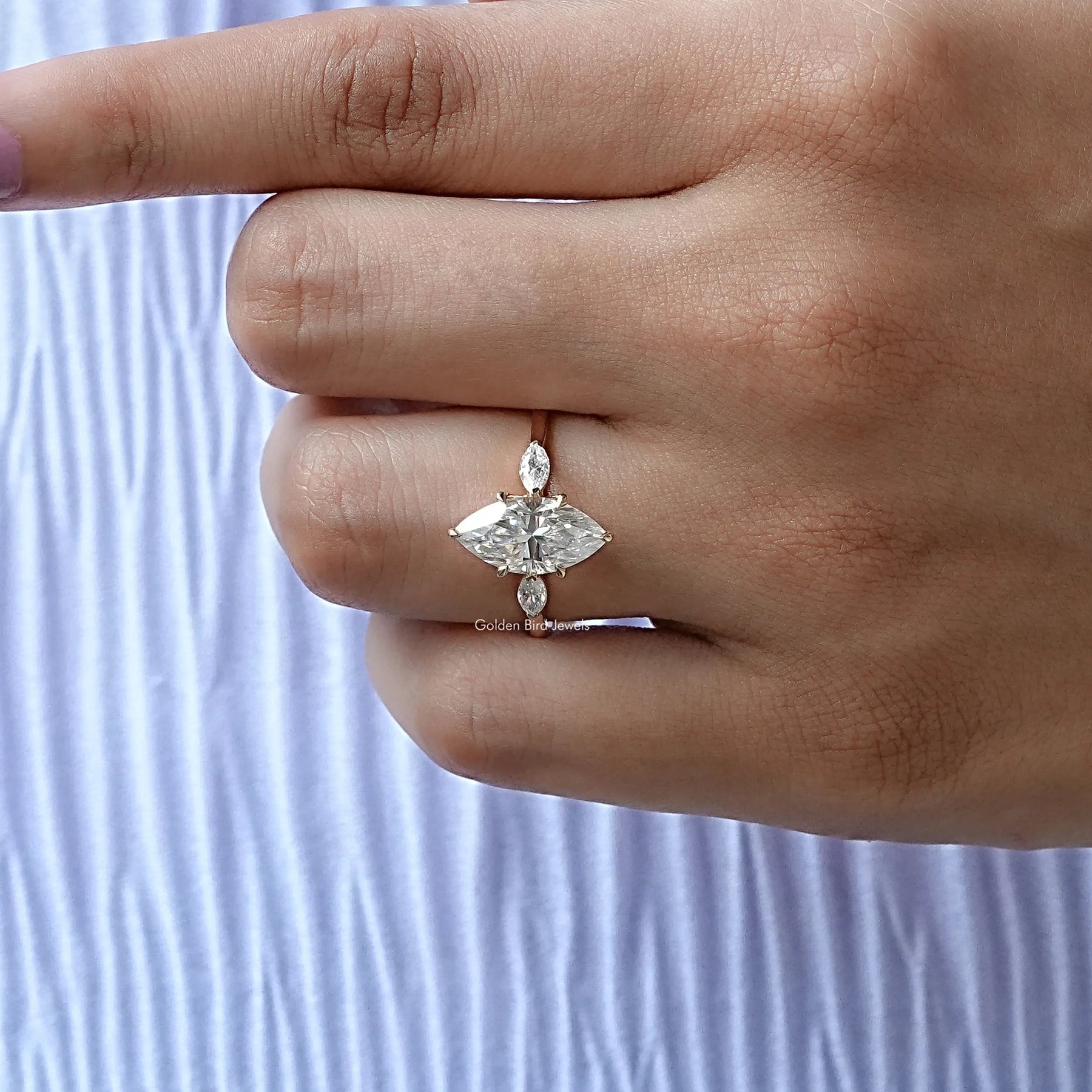 Detailed View of Three Stone Marquise Cut Moissanite Ring In Yellow Gold