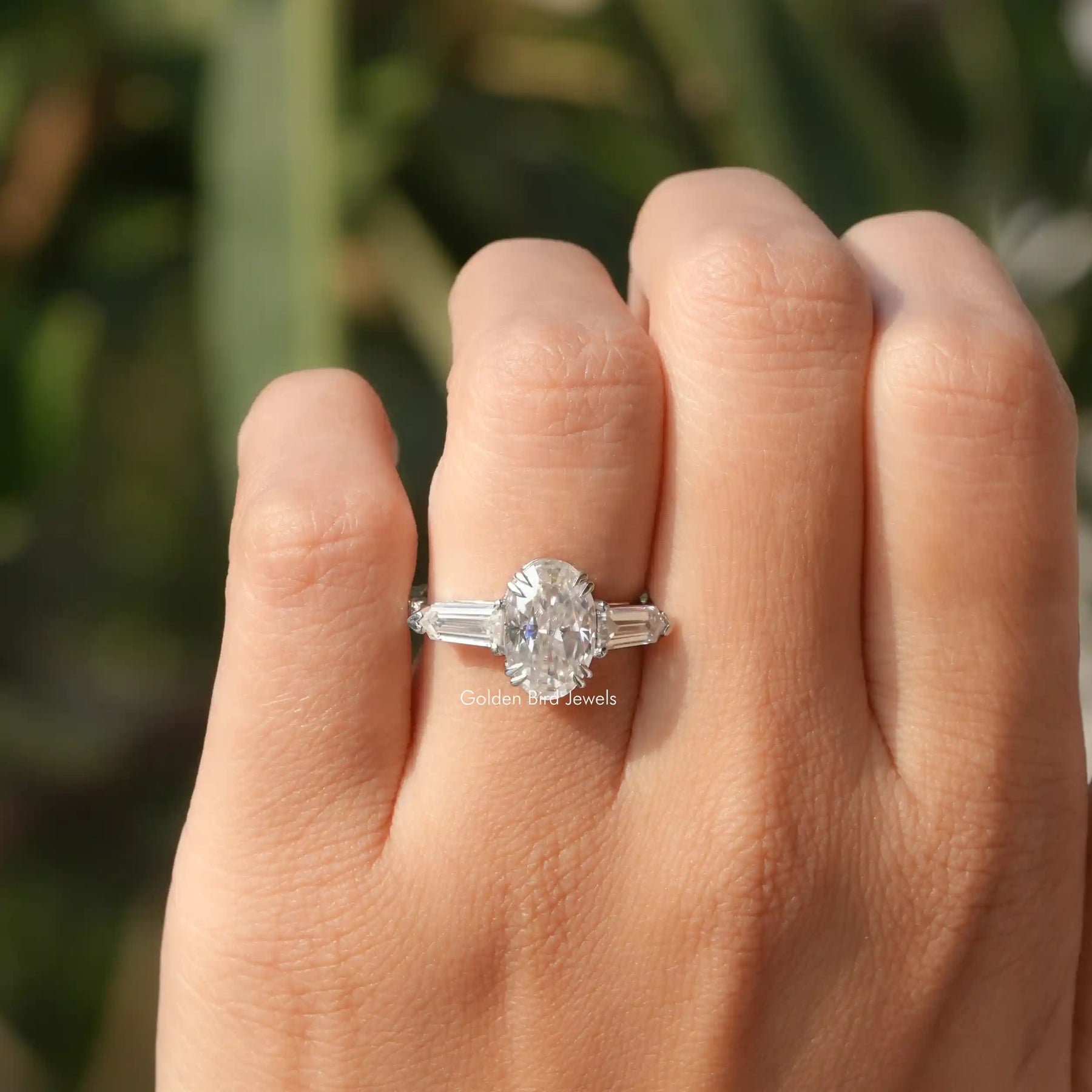 View of Oval And Bullet Cut Three Stone Ring In White Gold