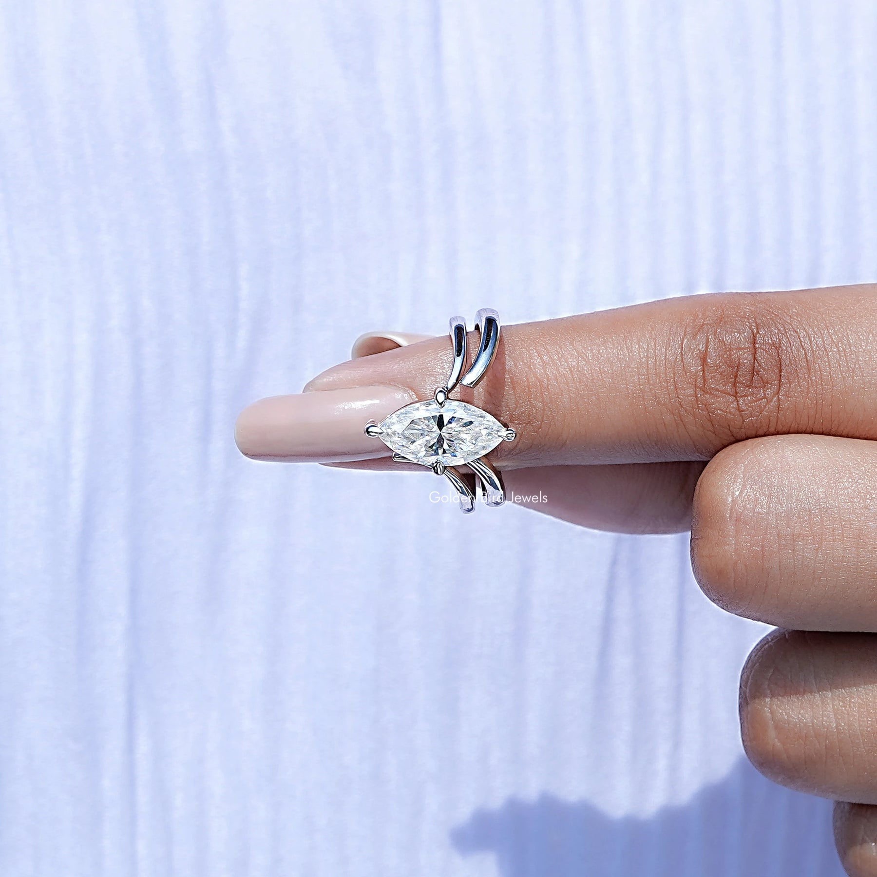 In finger front view of Marquise Cut Moissanite Solitaire Chevron Ring in unique shape