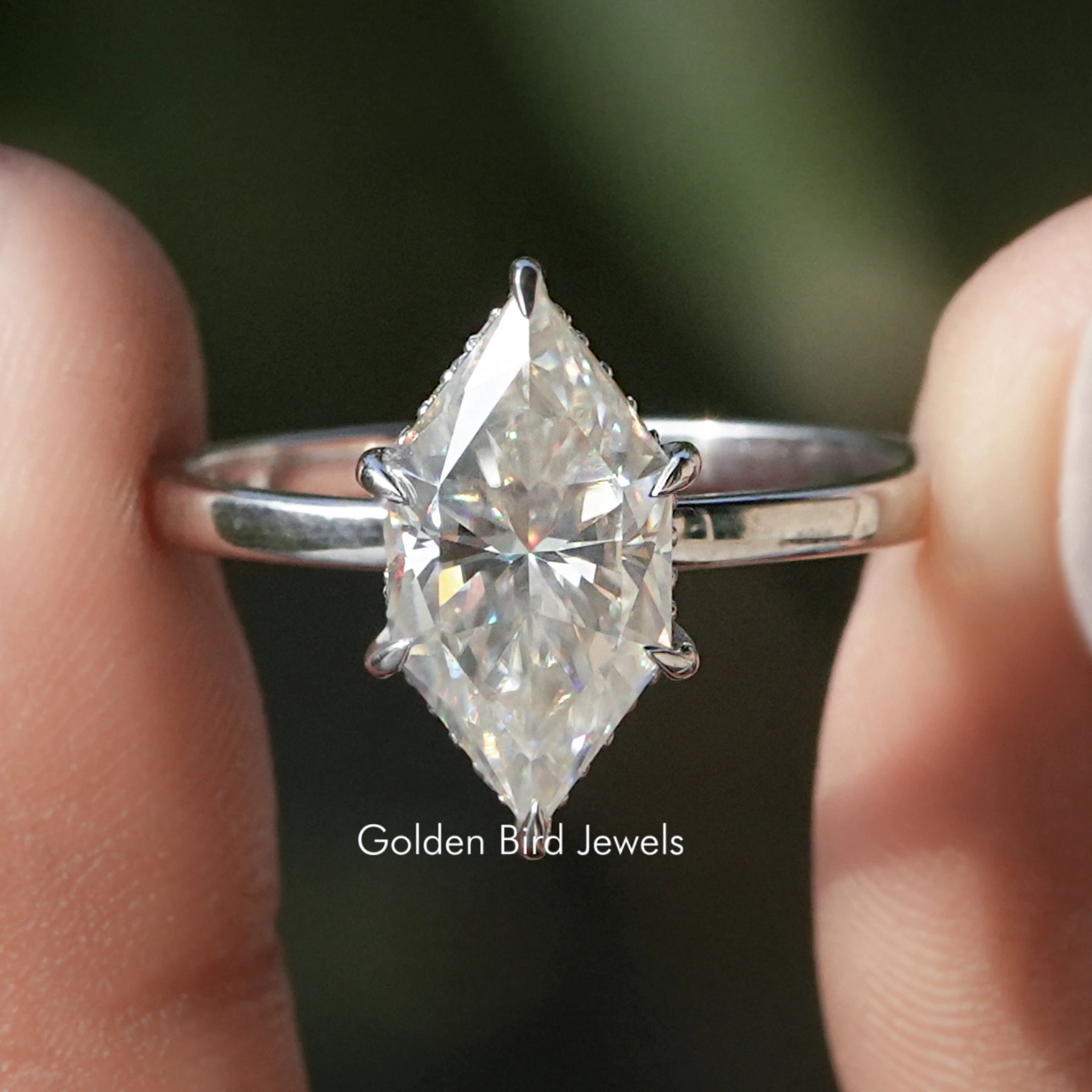 Front view of Dutch Marquise Cut Moissanite Hidden Halo Ring in two fingers