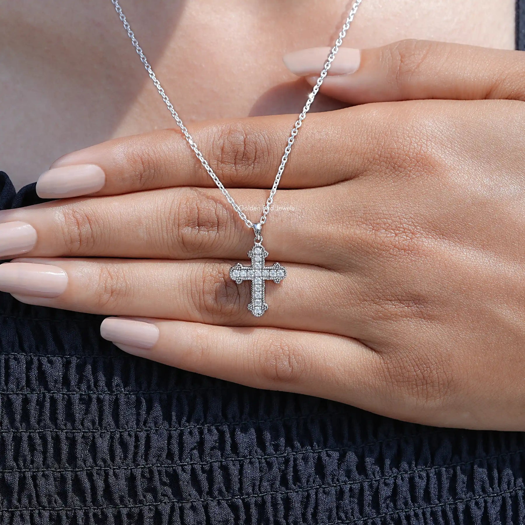In Hand Showing View Of Round Cut Moissanite Encrusted Cross Pendant