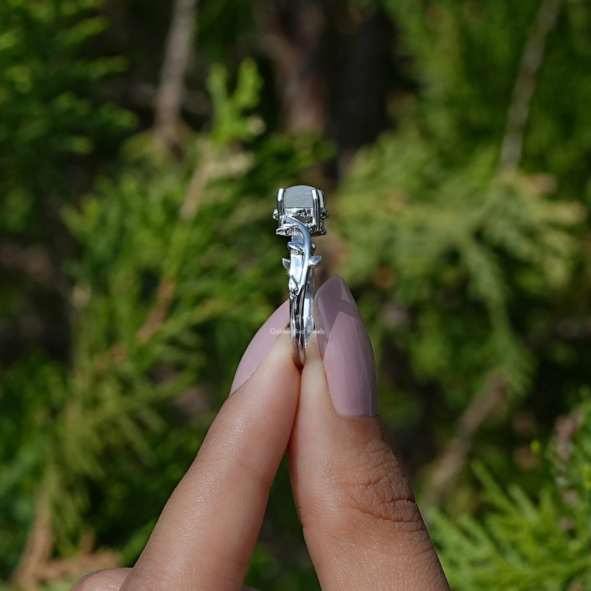 Side View of Round Cut Gemstone Solitaire Ring In two fingers