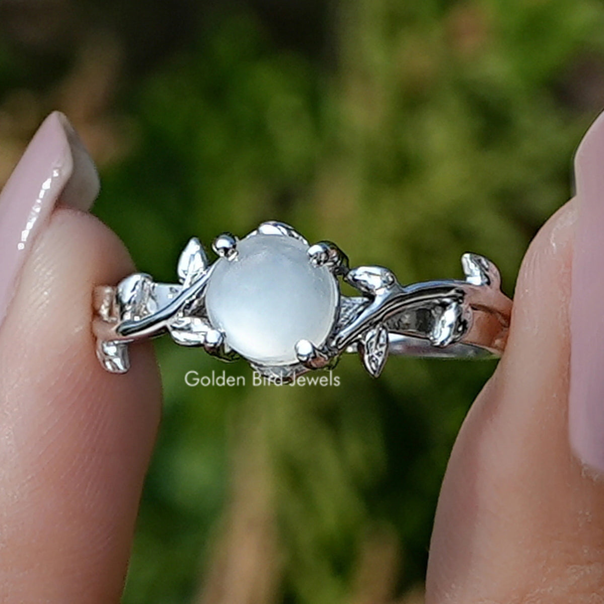 Front view of White Moonstone Round Gemstone Solitaire Ring Set in two fingers