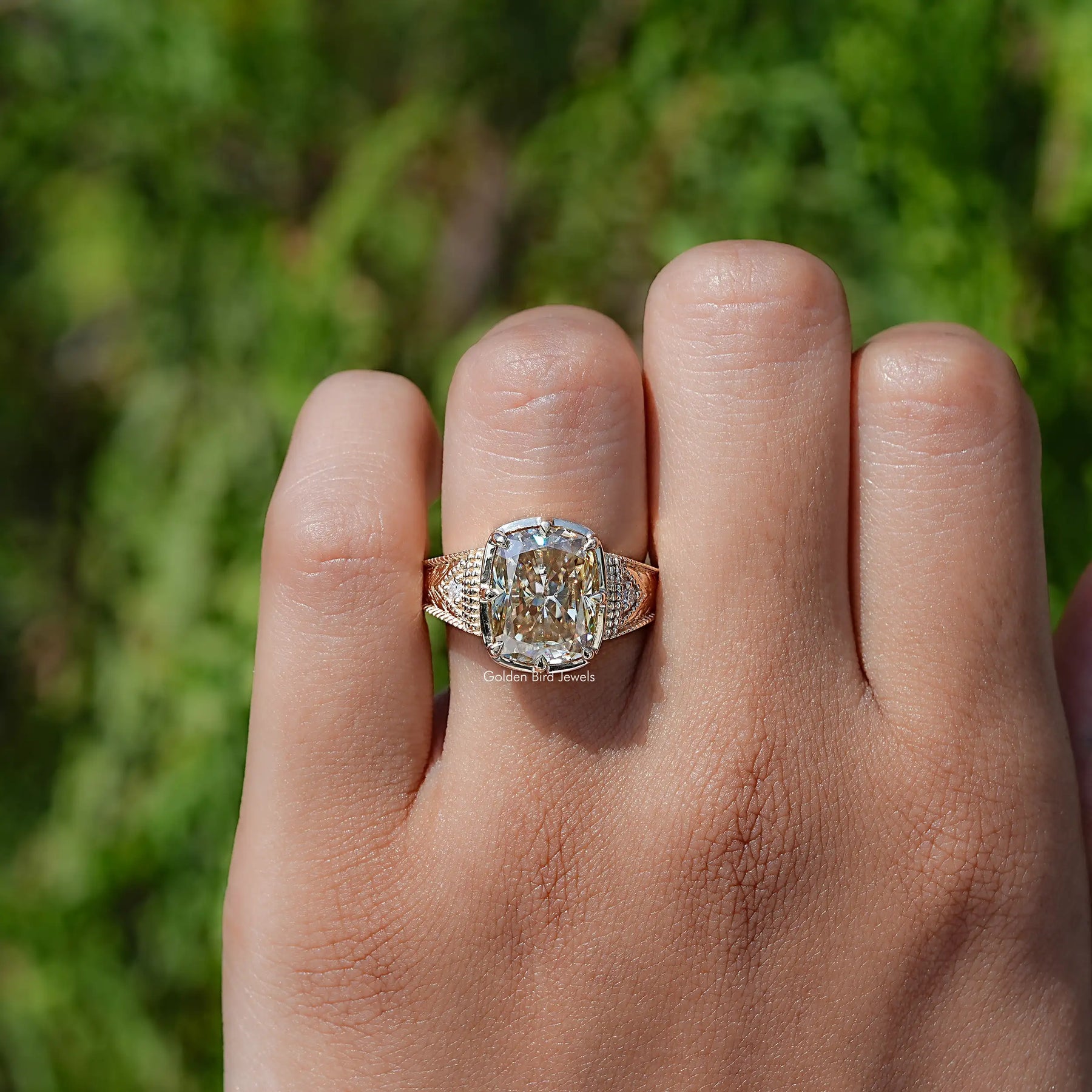 In finger front view of Filigree Yellow Elongated cushion Moissanite Ring