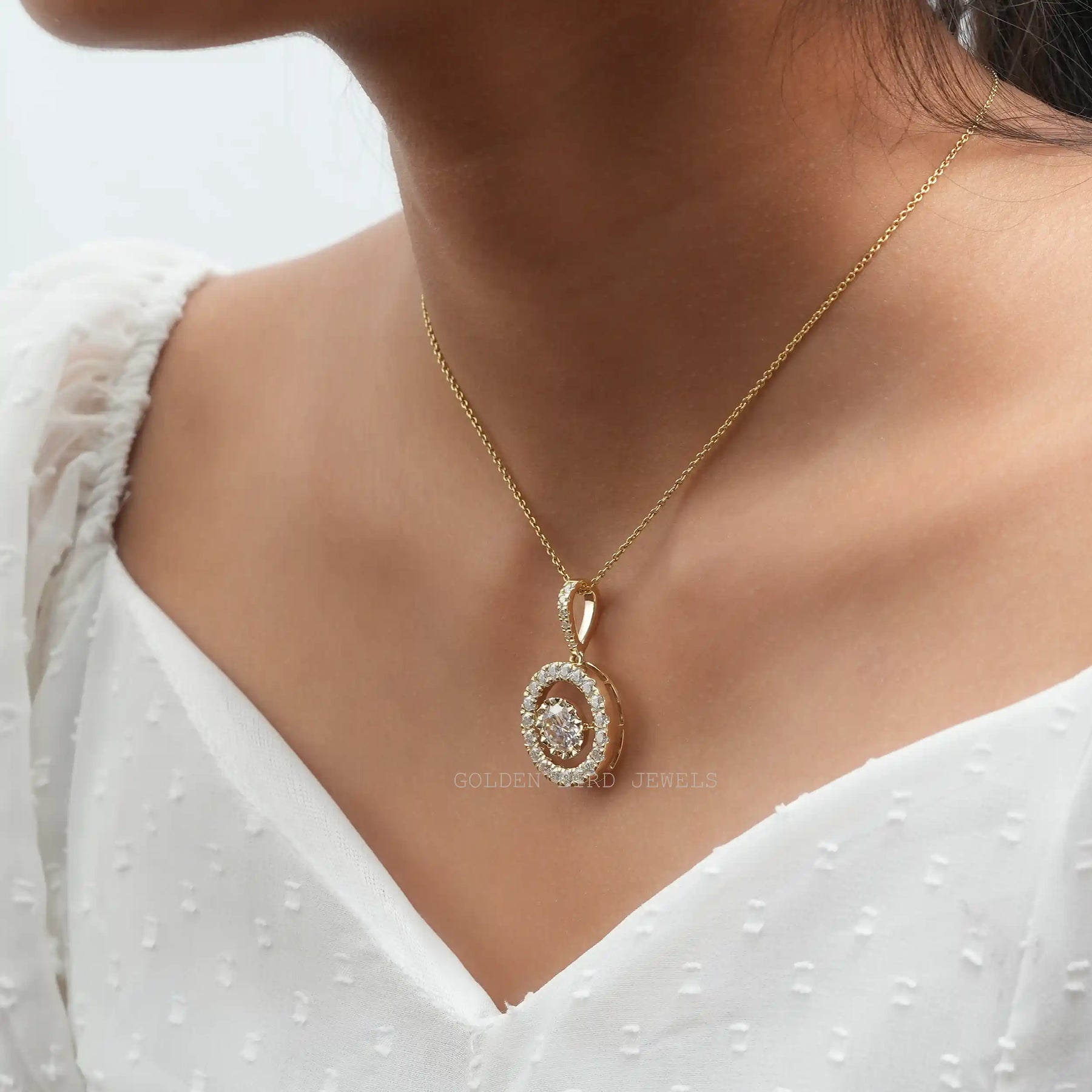 In neck front view of yellow gold round cut moissanite pendant