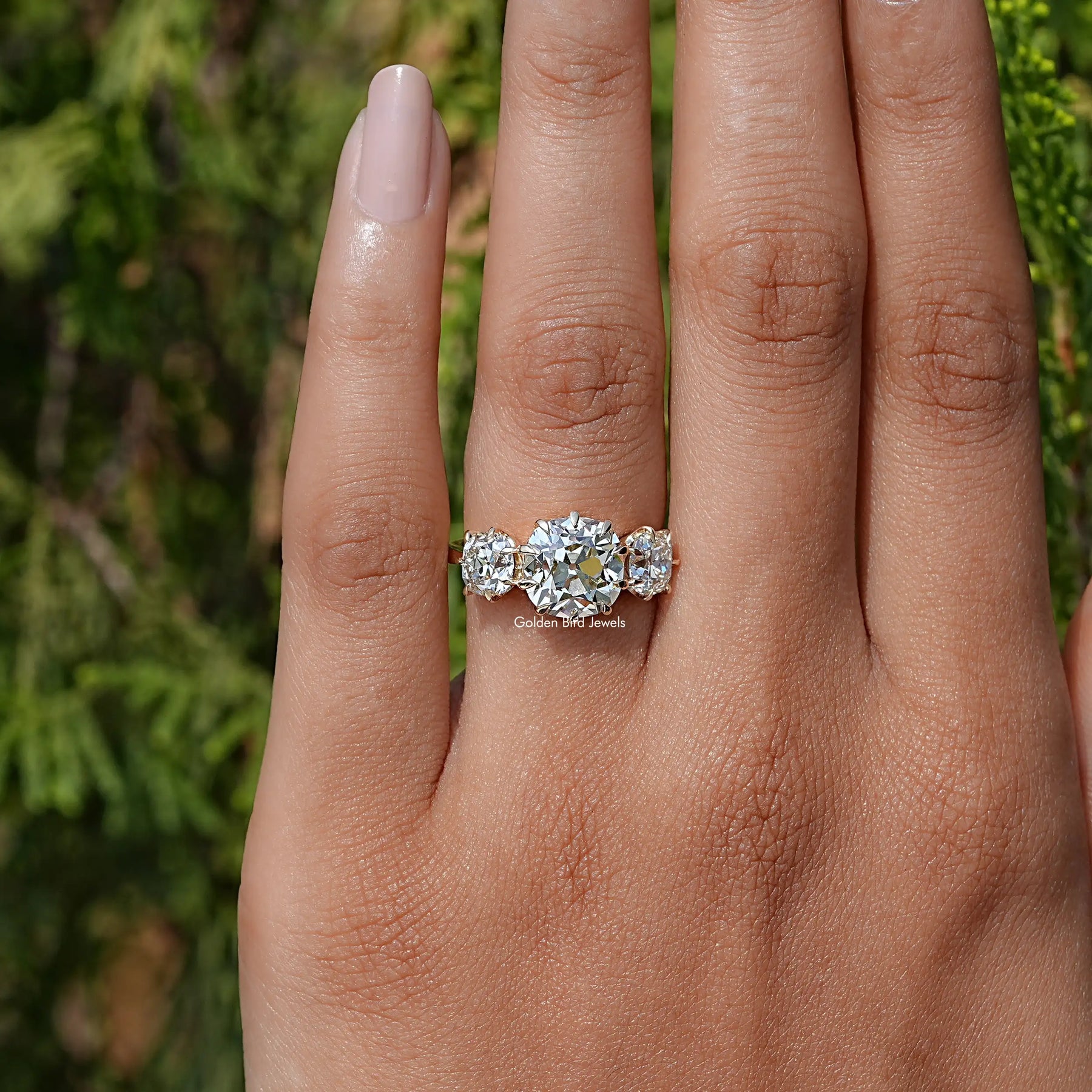 View of Old Mine Cushion Cut Diamond Three Stone Ring In Yellow Gold