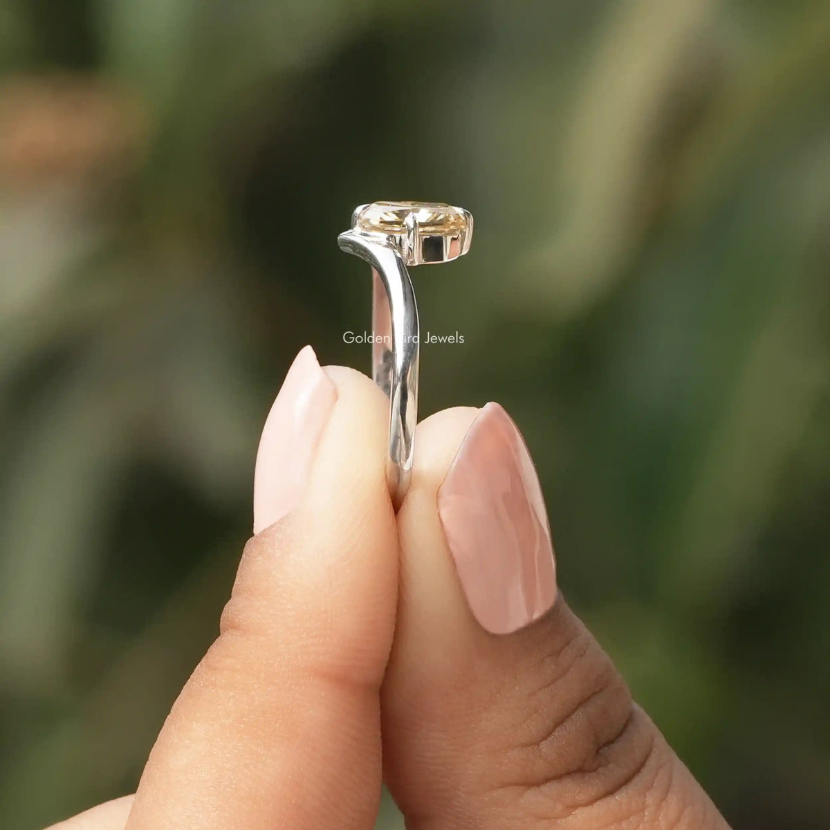 Side View of Moissanite Yellow Radiant Cut Solitaire Ring In two fingers