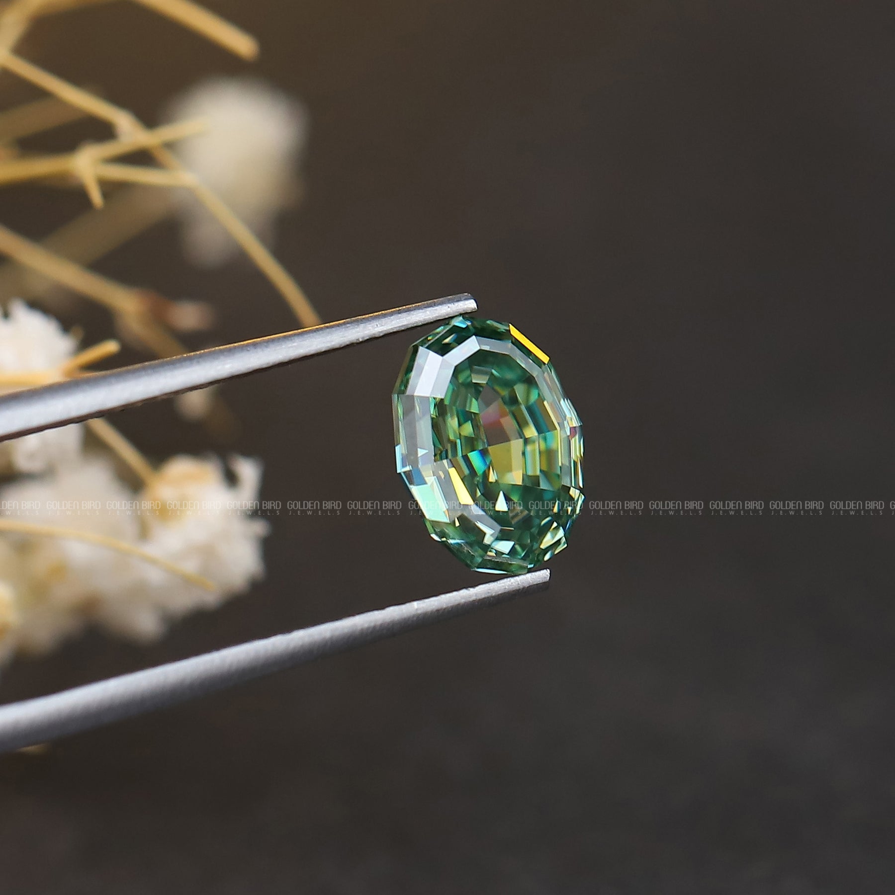 In Tweezer View Of Blue Green Oval Shape Loose Moissanite