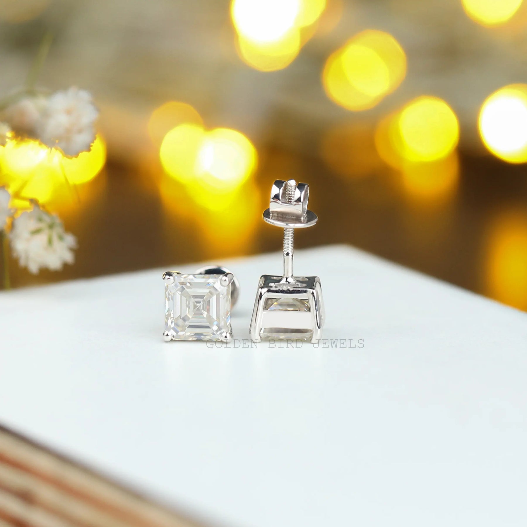 Front and back view of solitaire moissanite earrings