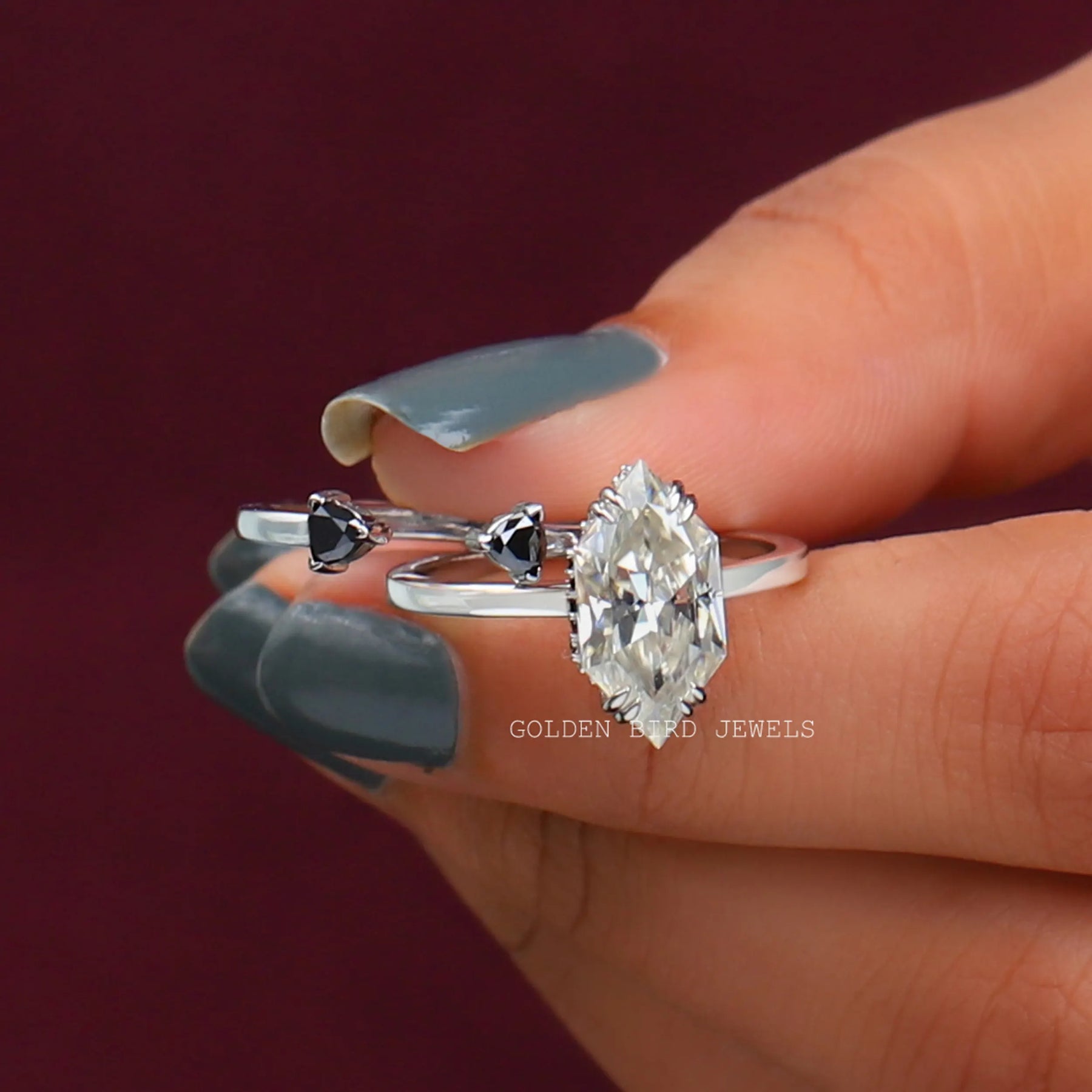 Front View of Hidden Halo Marquise Engagement Ring In two Fingers