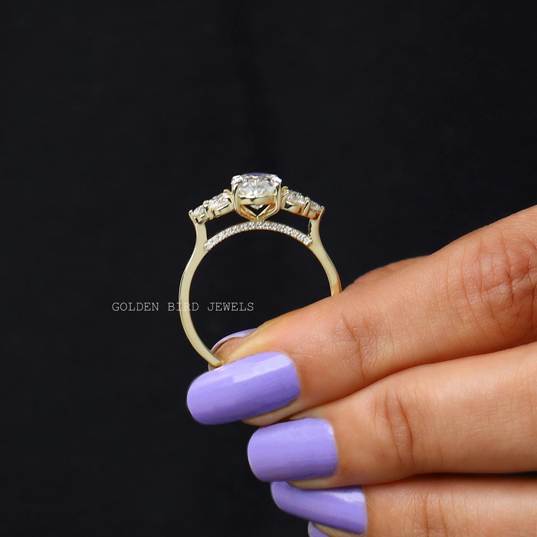 Back view of Oval crushed moissanite engagement ring in two fingers