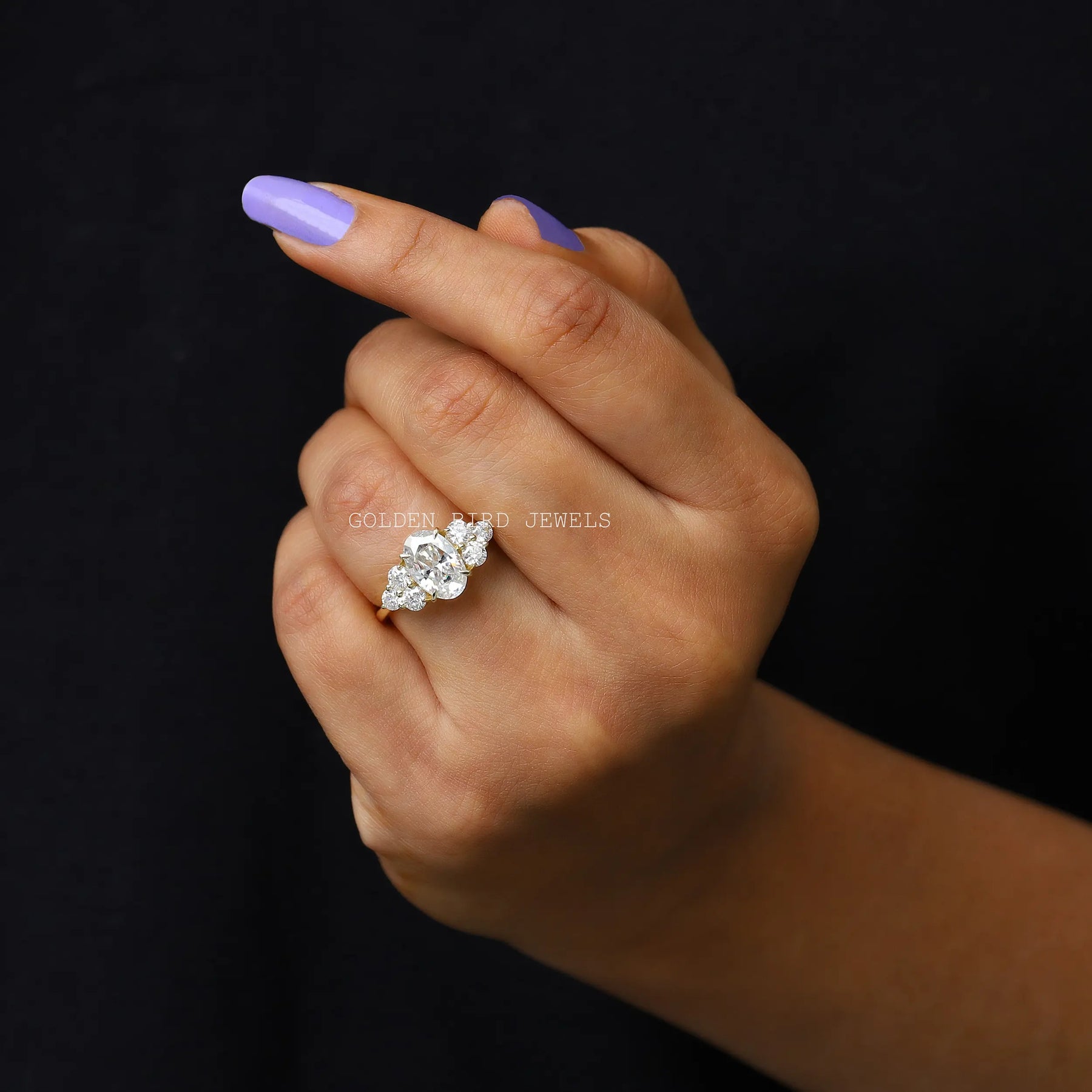 Finger view of cluster moissanite engagement ring