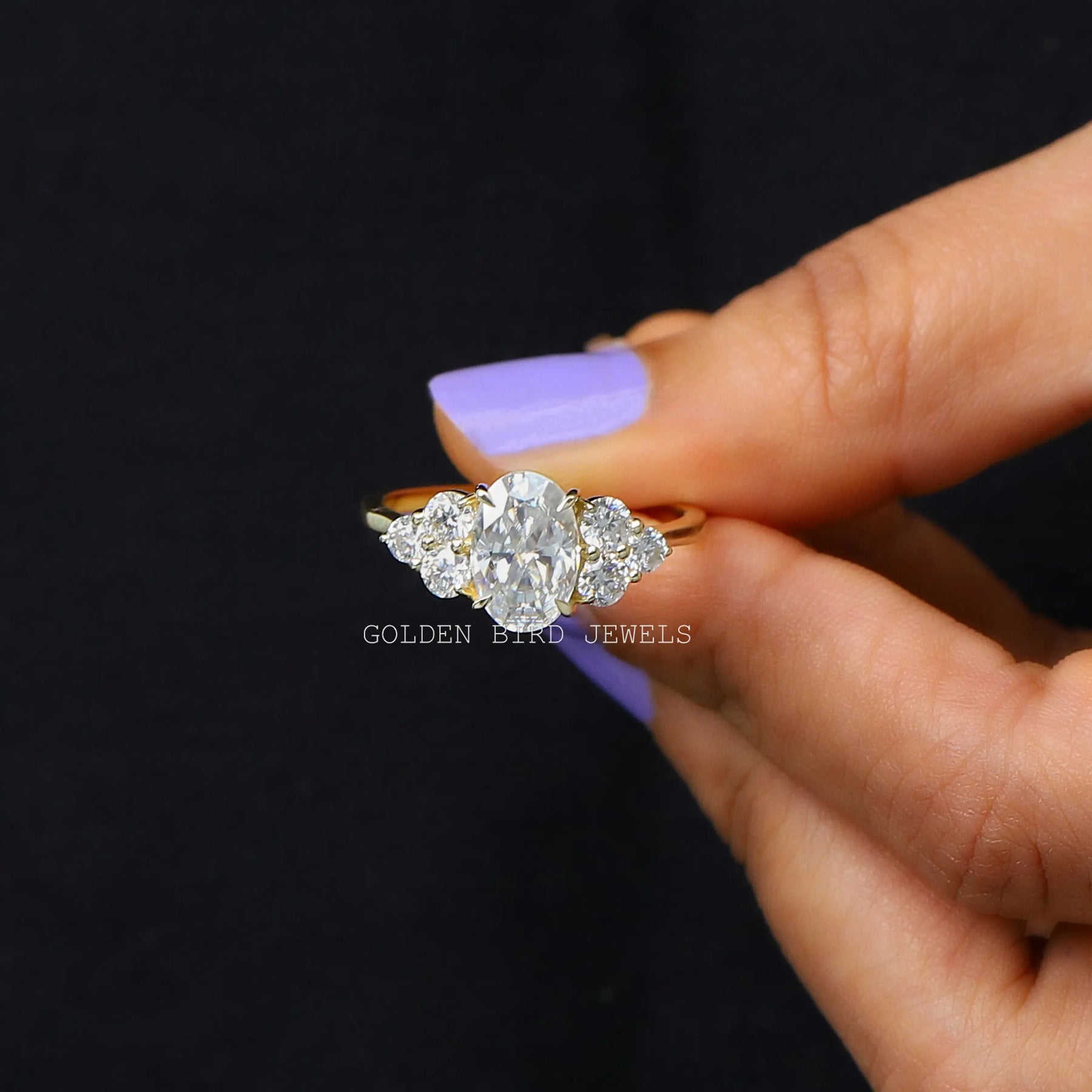 Moissanite engagement ring holding on two fingers