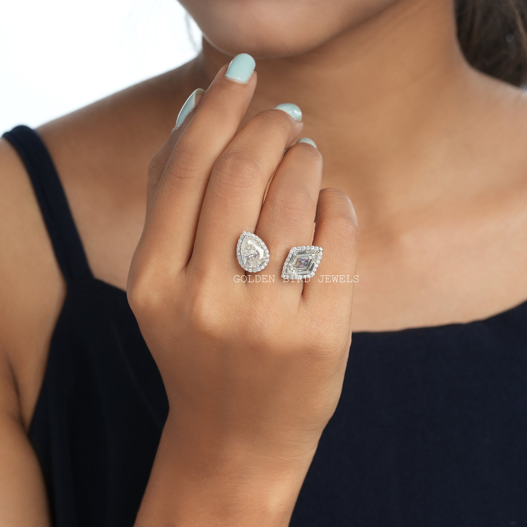 Finger view of toi-et-moi halo moissanite engagement ring