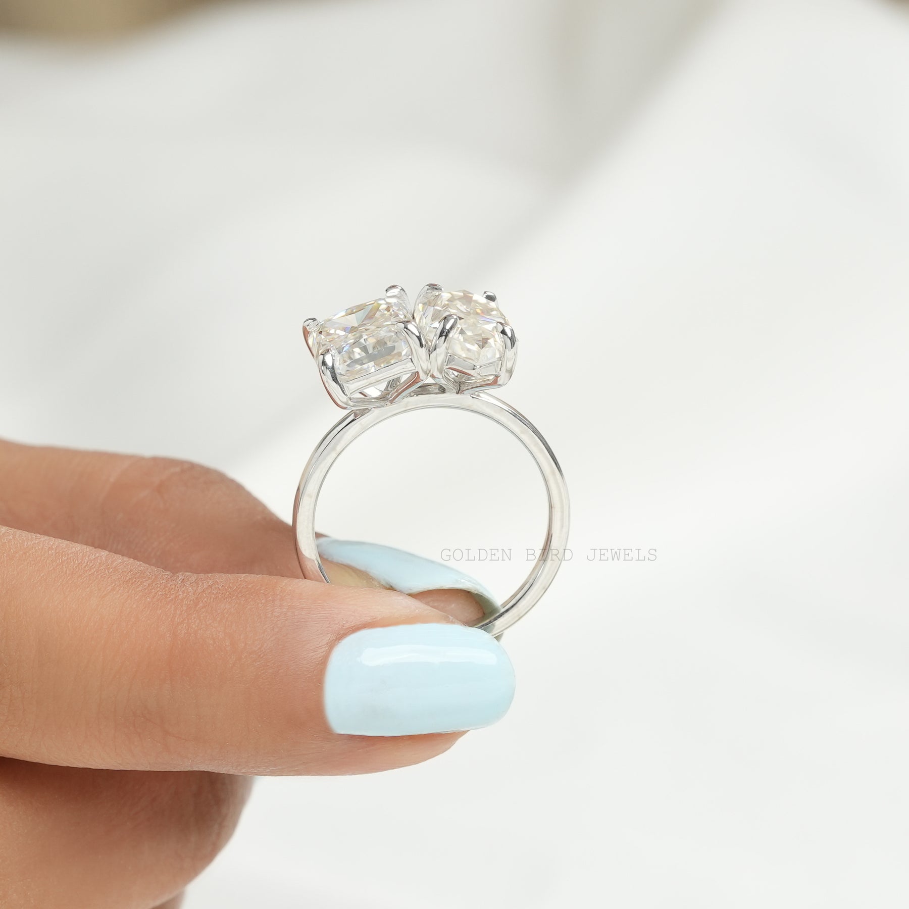 Back View of Dutch Marquise & Radiant Cut Moissanite Toi Et Moi Ring In two fingers