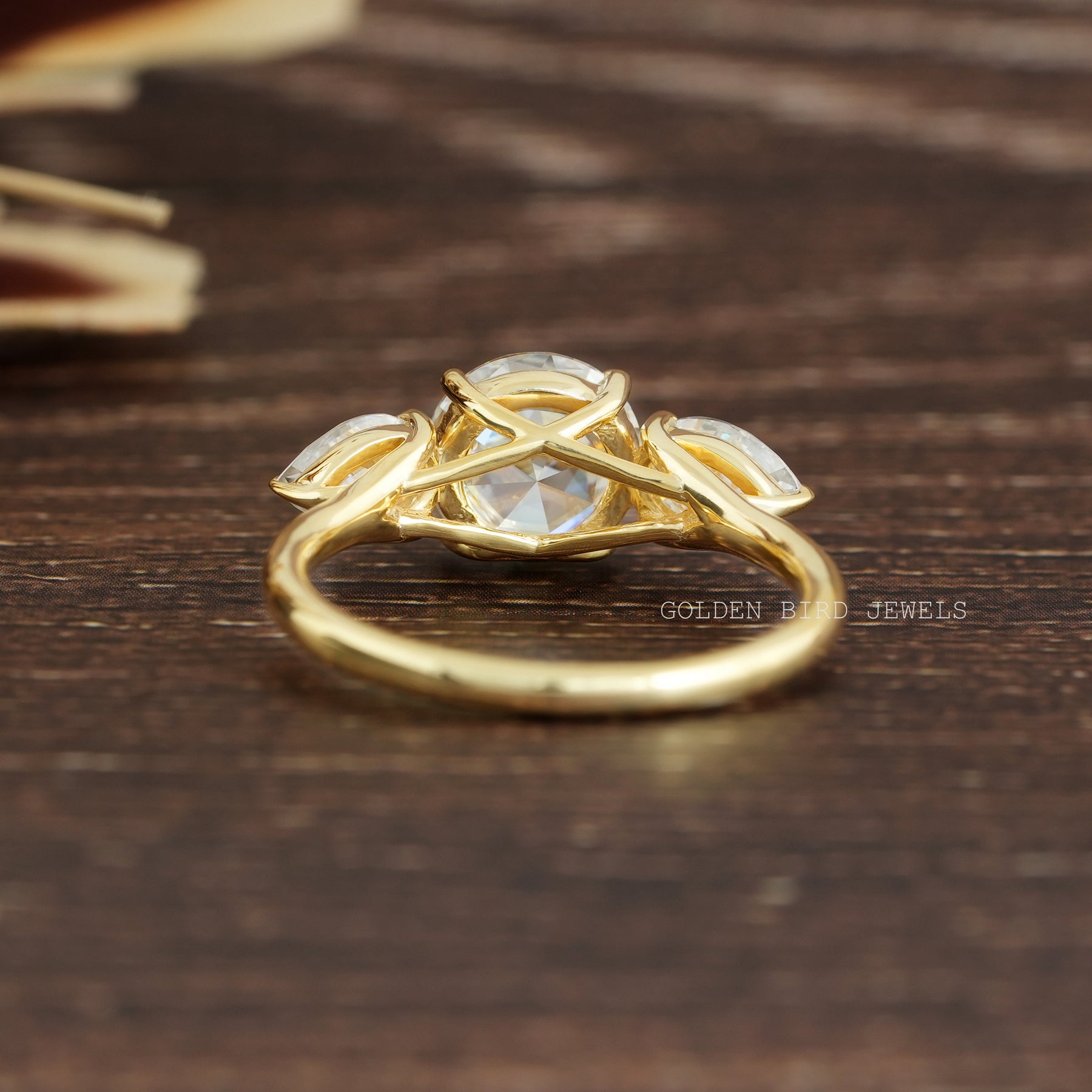 View of Round And Pear Cut Three Stone Ring In Finger