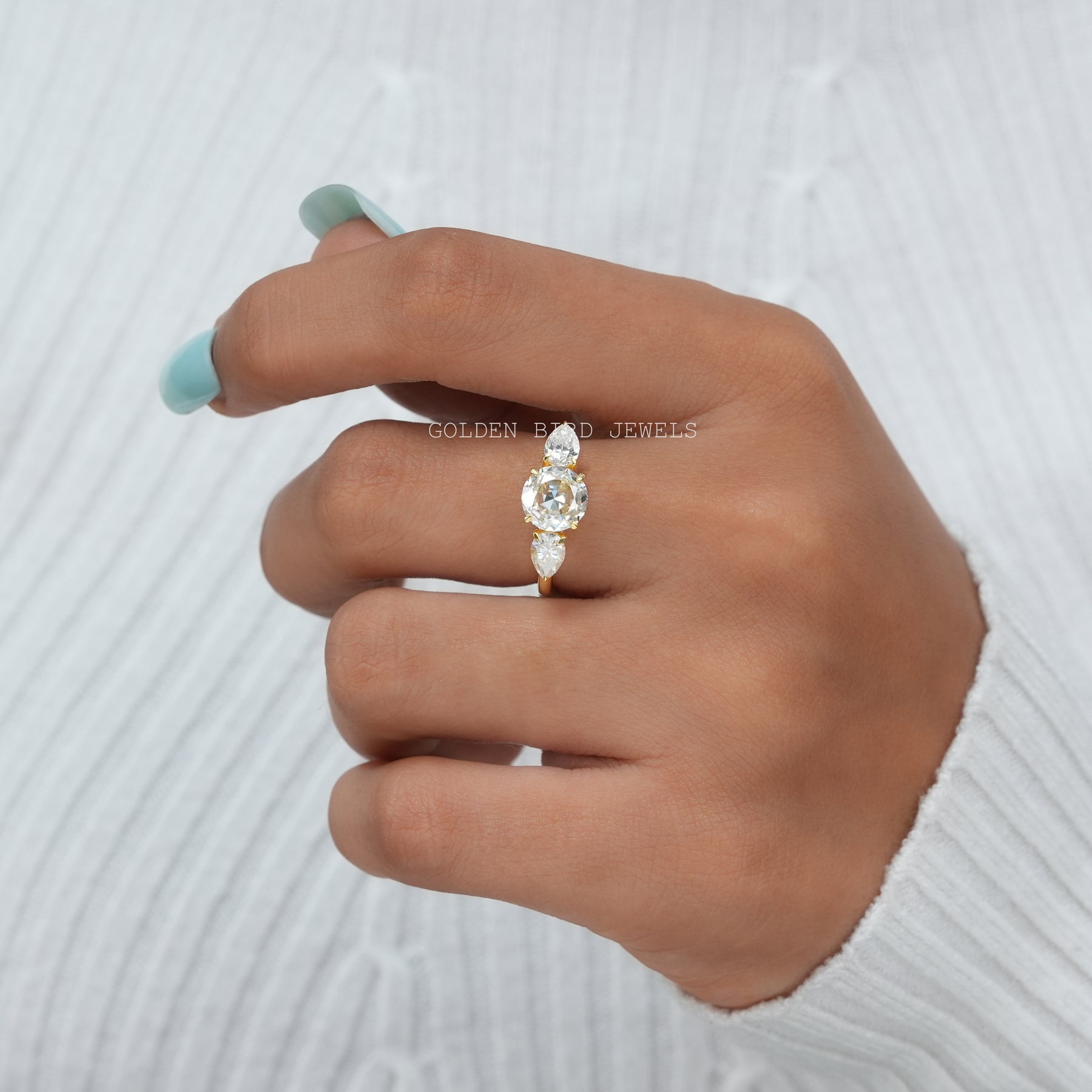 View of Round Cut Moissanitee Three Stone Engagement Ring In Finger