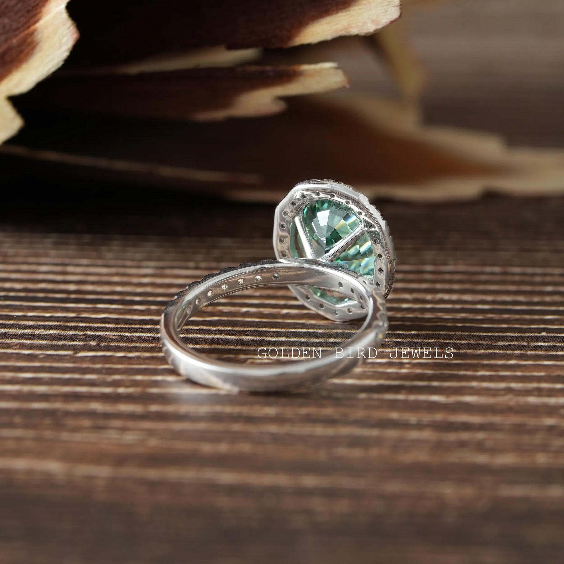 Dark green oval moissanite engagement ring in secure setting