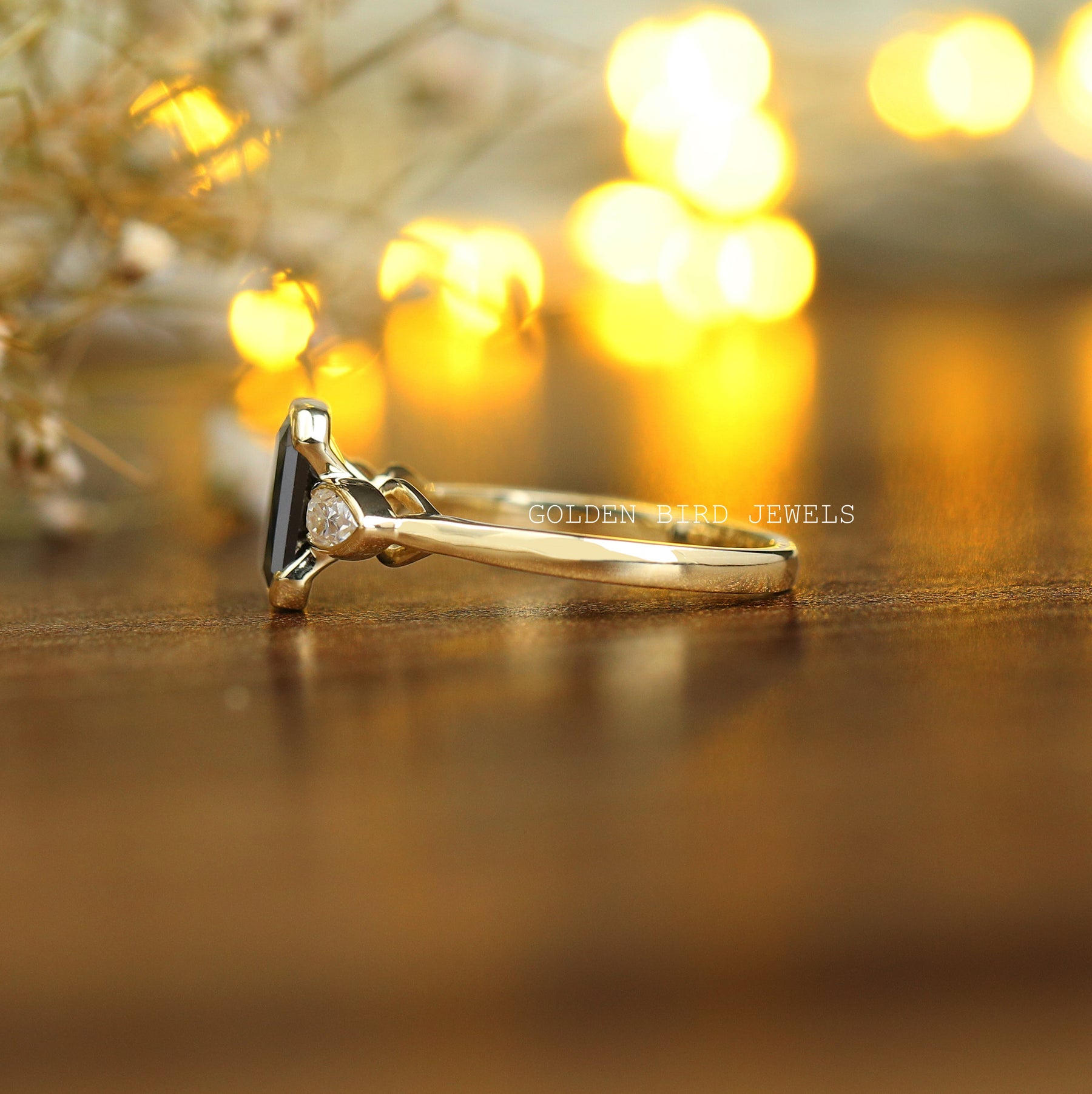 Side view of a moissanite engagement ring in yellow gold
