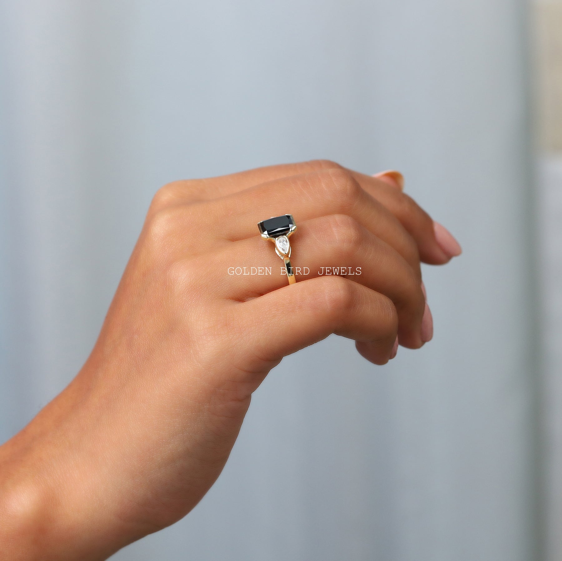 in a finger side view of moissanite ring with side diamonds