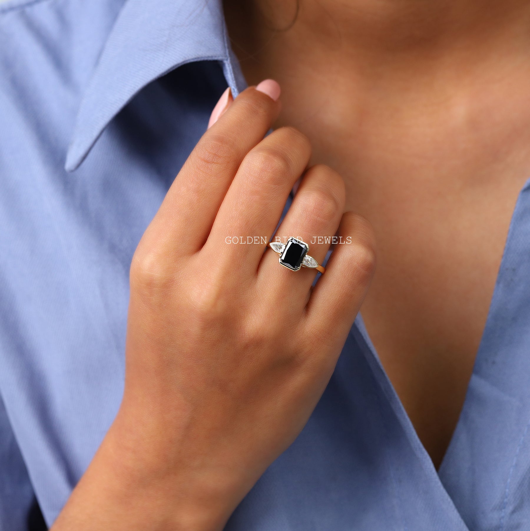 Finger view of Moissanite Radiant And Pear Cut Three Stone Ring
