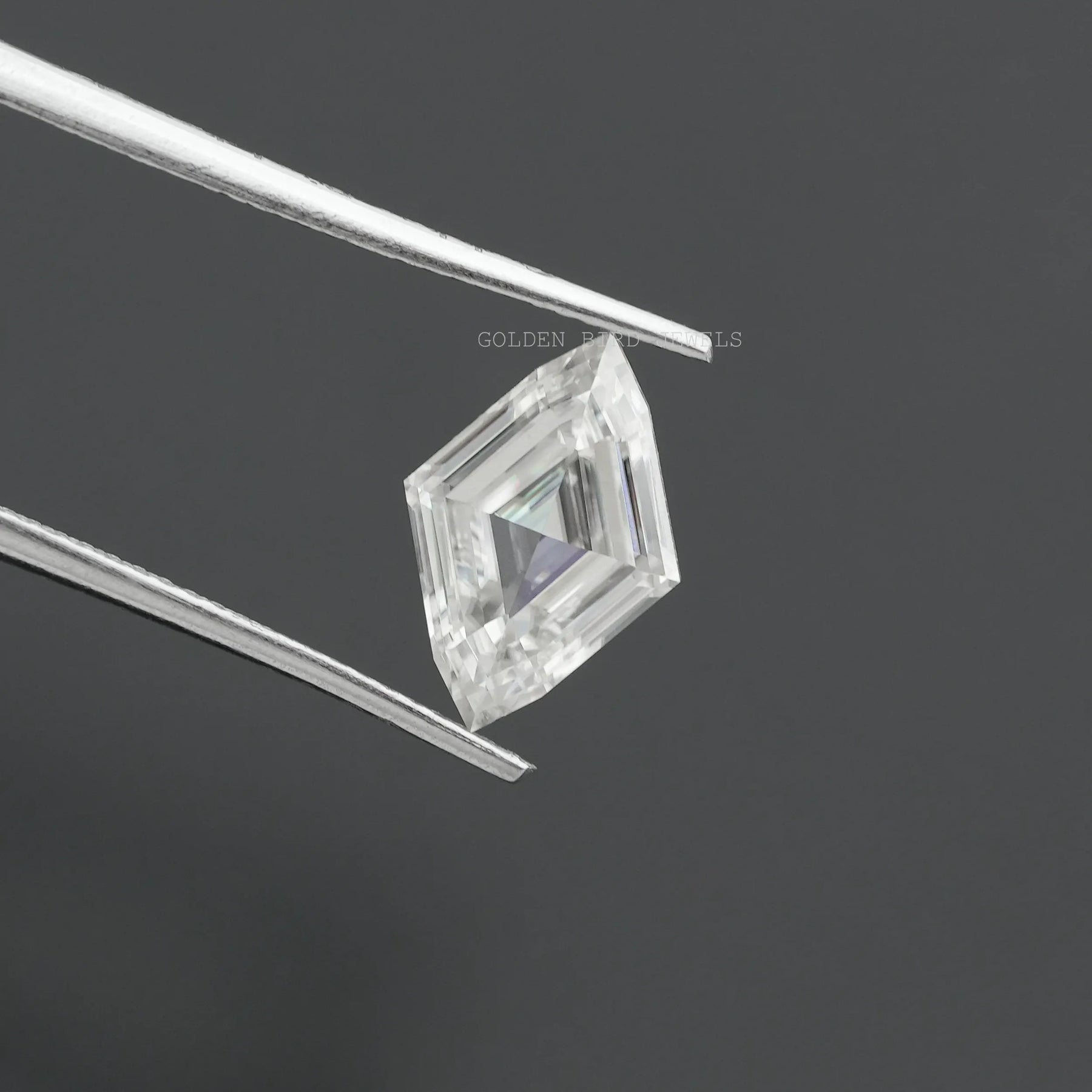 Tweezers holding the Antique Marquise Cut Moissanite Stone