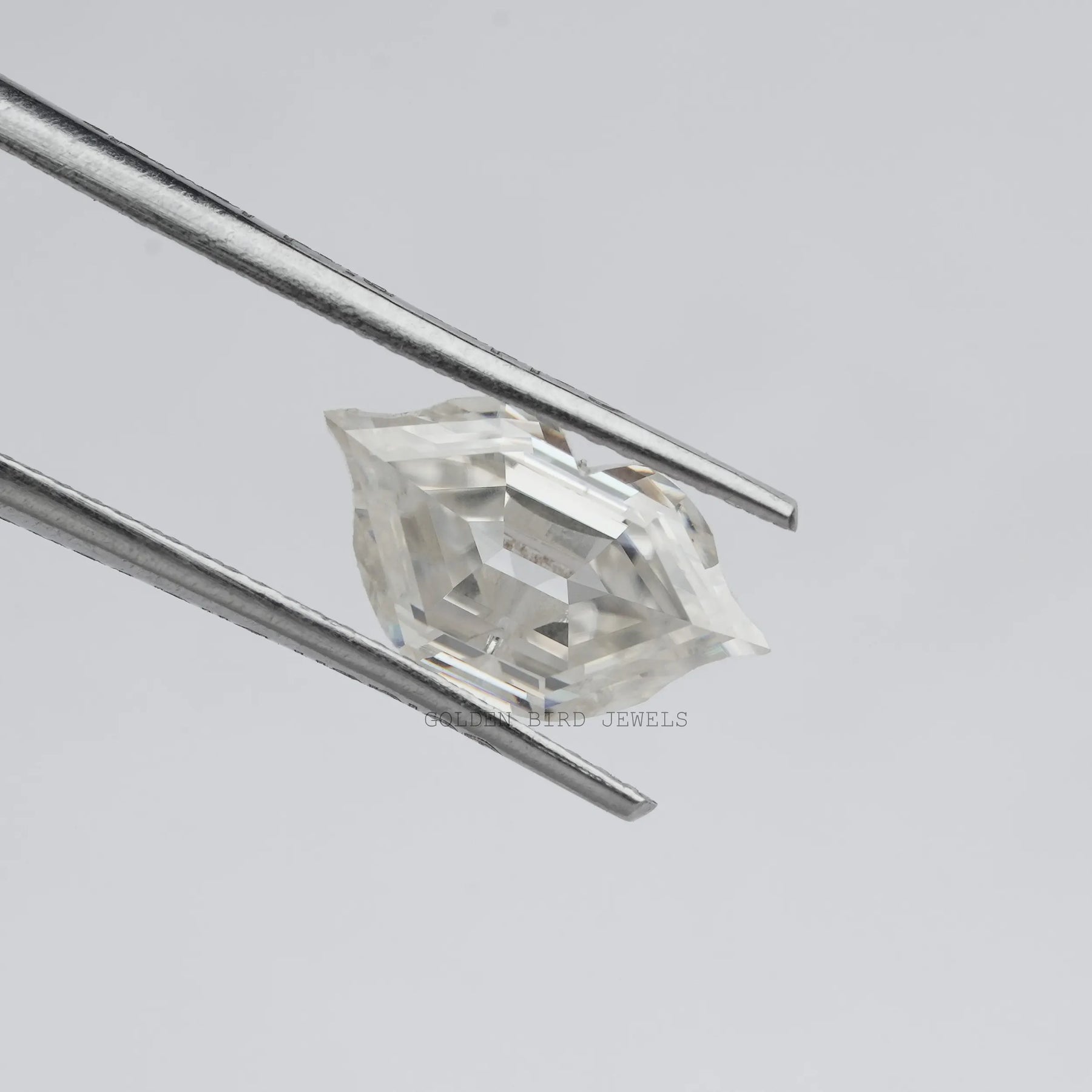 Tweezer holding the Moissanite Lips Shapes Loose Moissanite