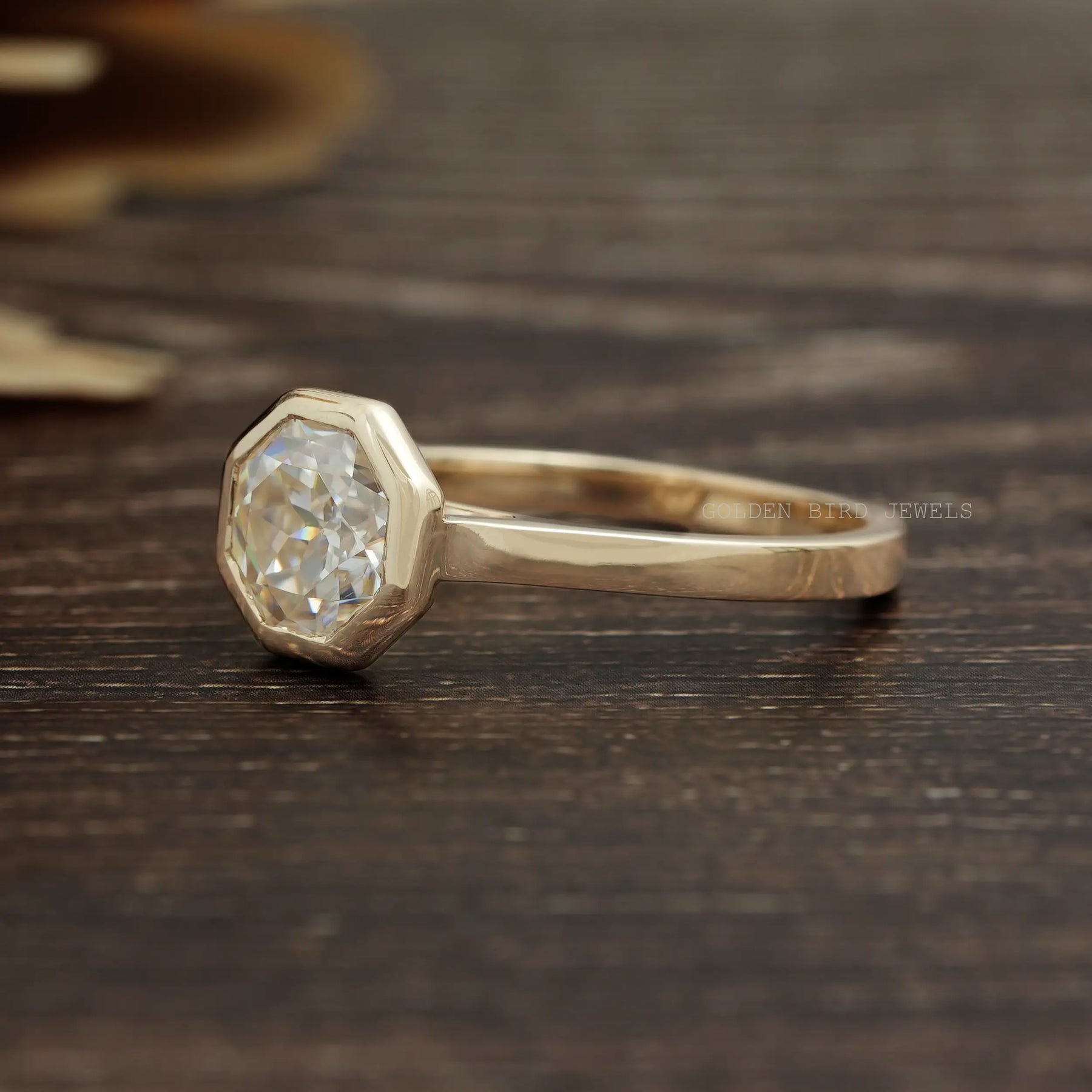 View of Bezel Set Octagon Cut Moissanite Solitaire Ring In Yellow Gold